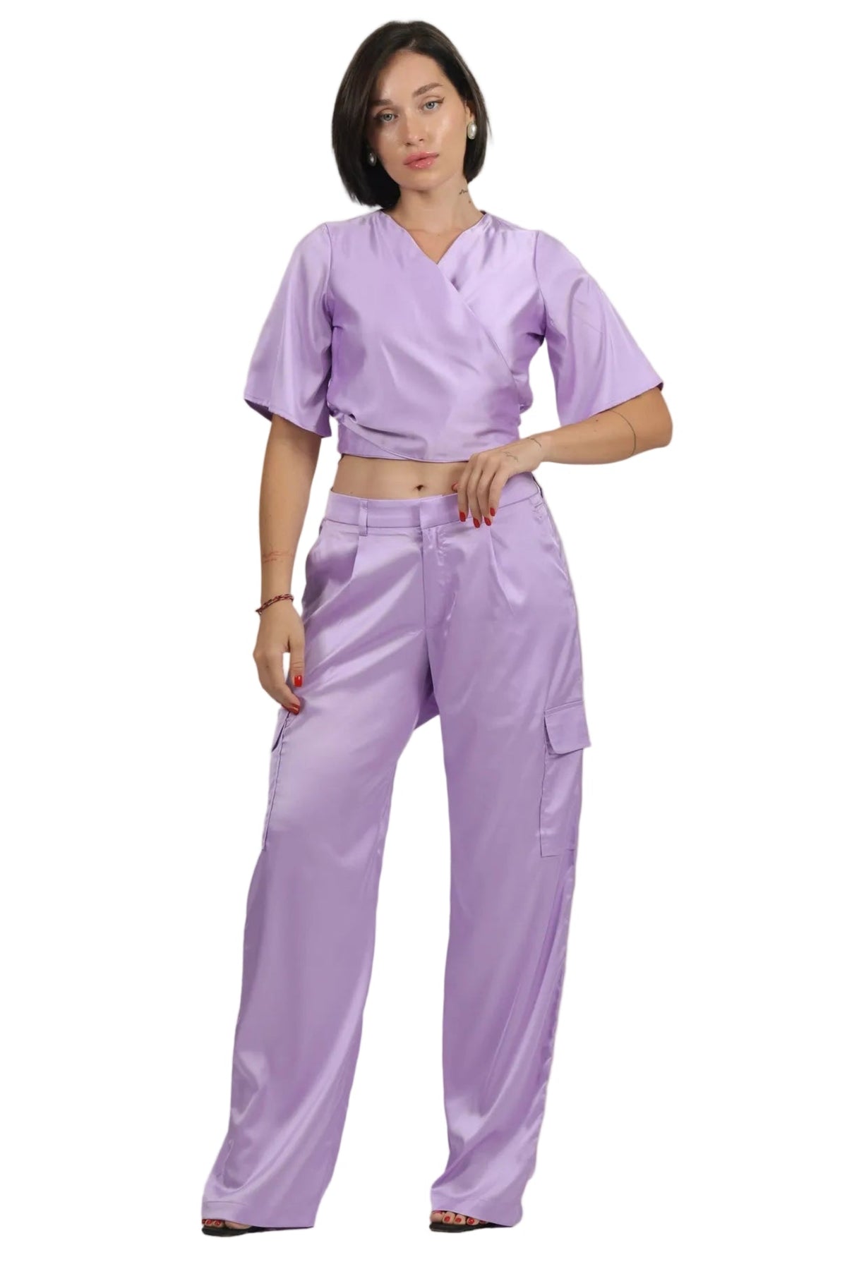 A woman modeling a two-piece set in light purple, featuring a short-sleeve V-neck top and matching cargo pants, shot against a plain white background.