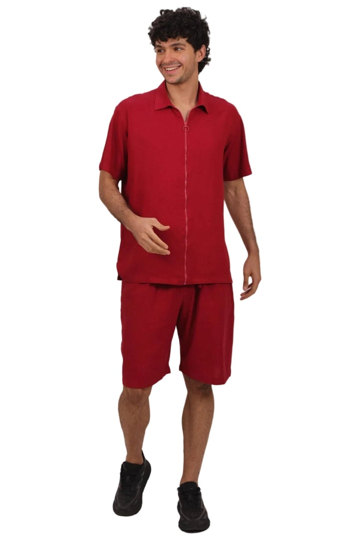 A man modeling a matching red short-sleeve button-up shirt and shorts set, standing against a plain white background.
