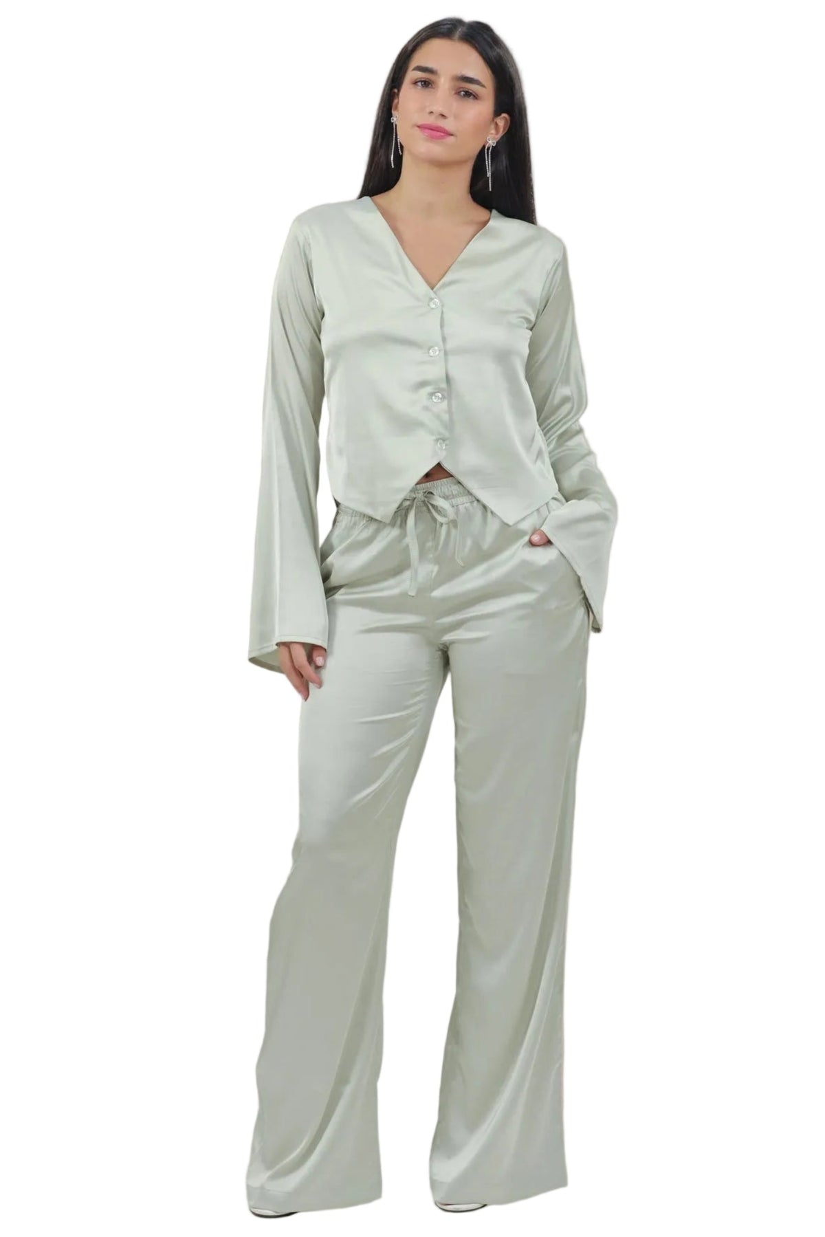 Woman wearing a light green outfit on a beige background