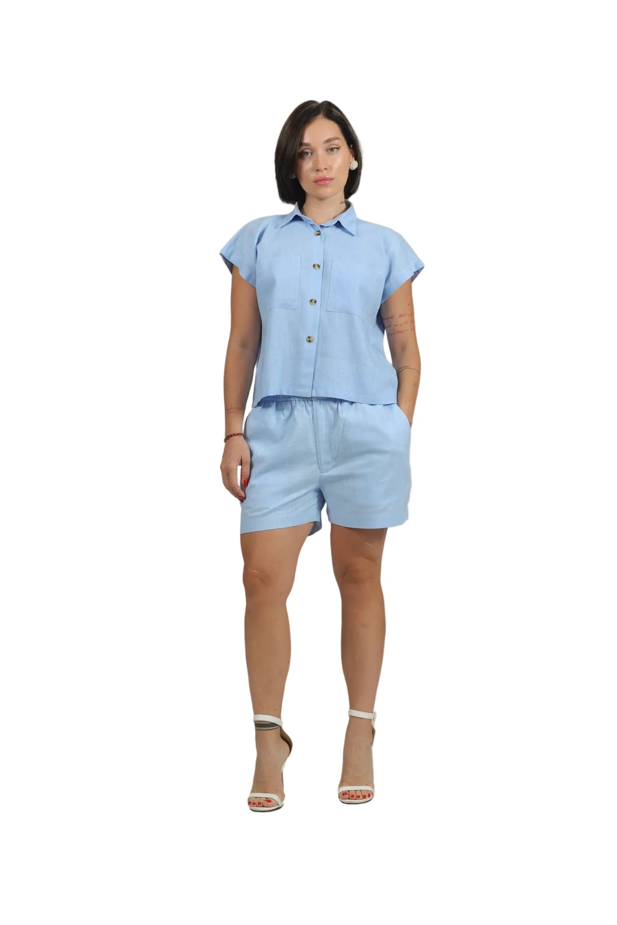 Woman wearing a light blue outfit on a beige background