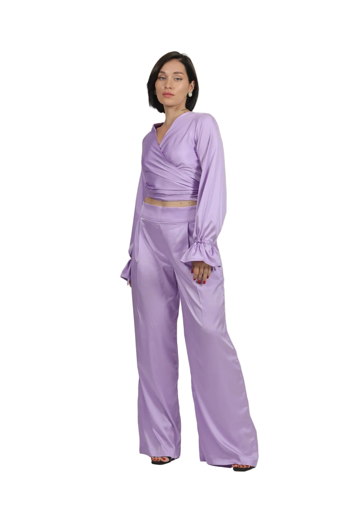 Woman wearing a lavender outfit on a beige background