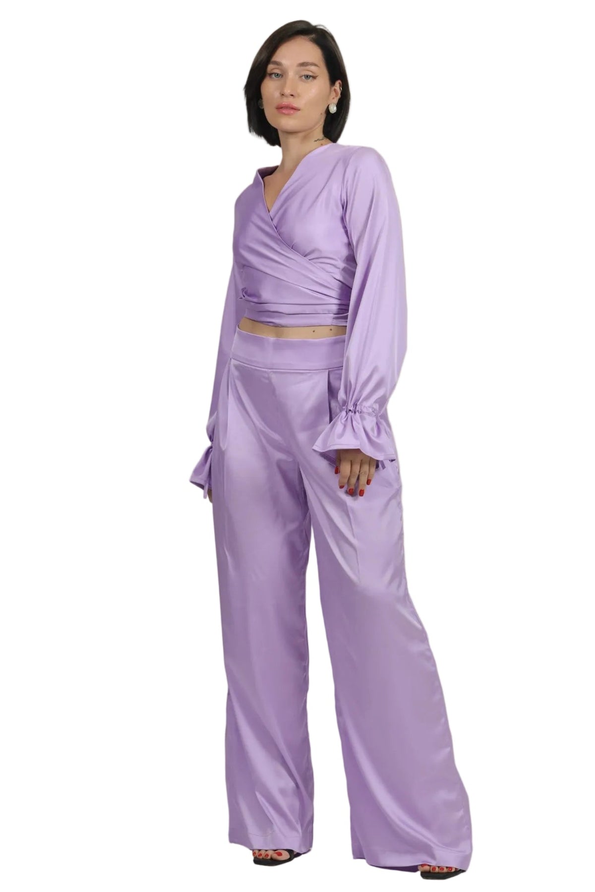 Woman wearing a lavender outfit on a beige background