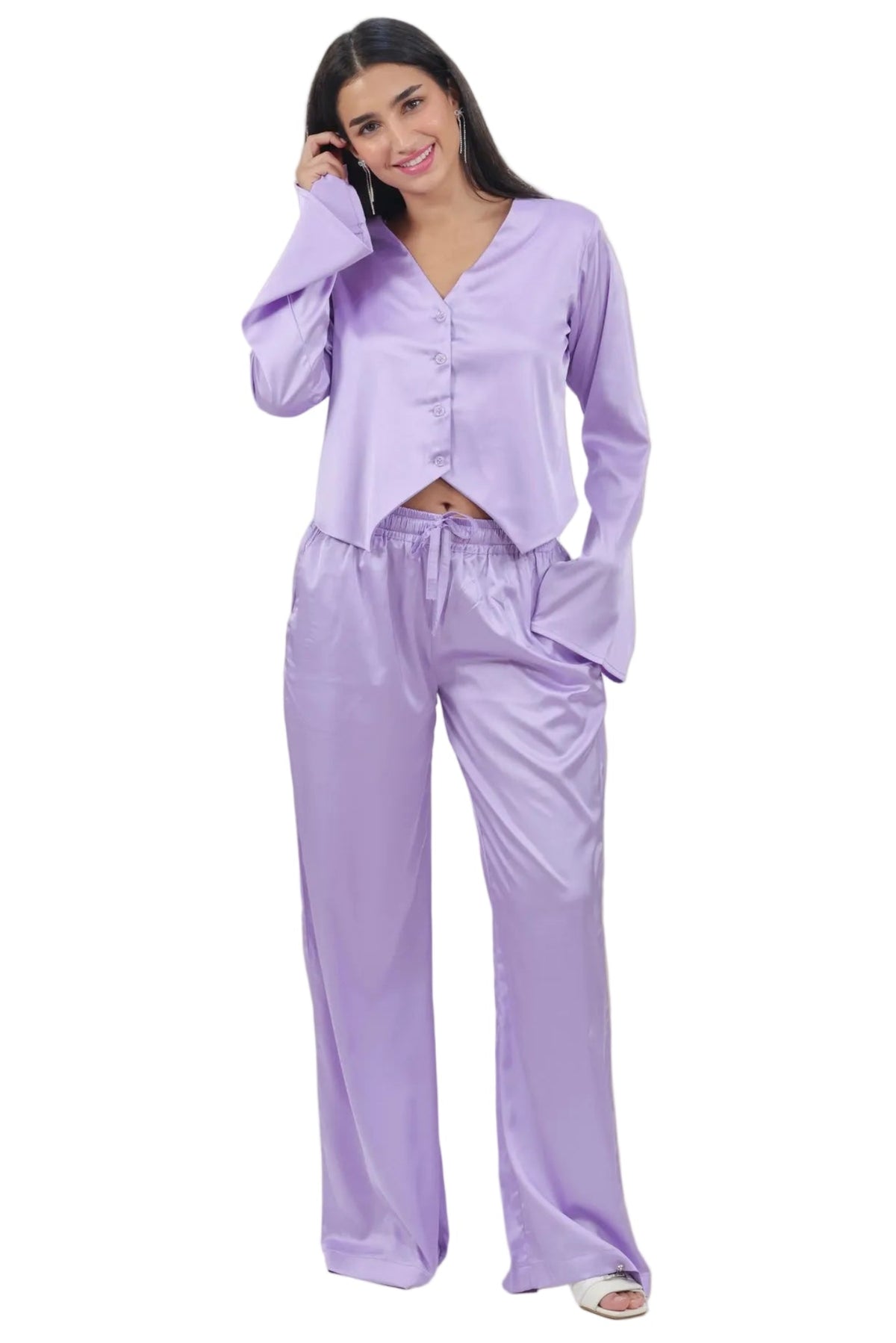 A woman modeling a two-piece lavender pajama set consisting of a long-sleeve button-front top and matching wide-leg pants, photographed against a plain white background.