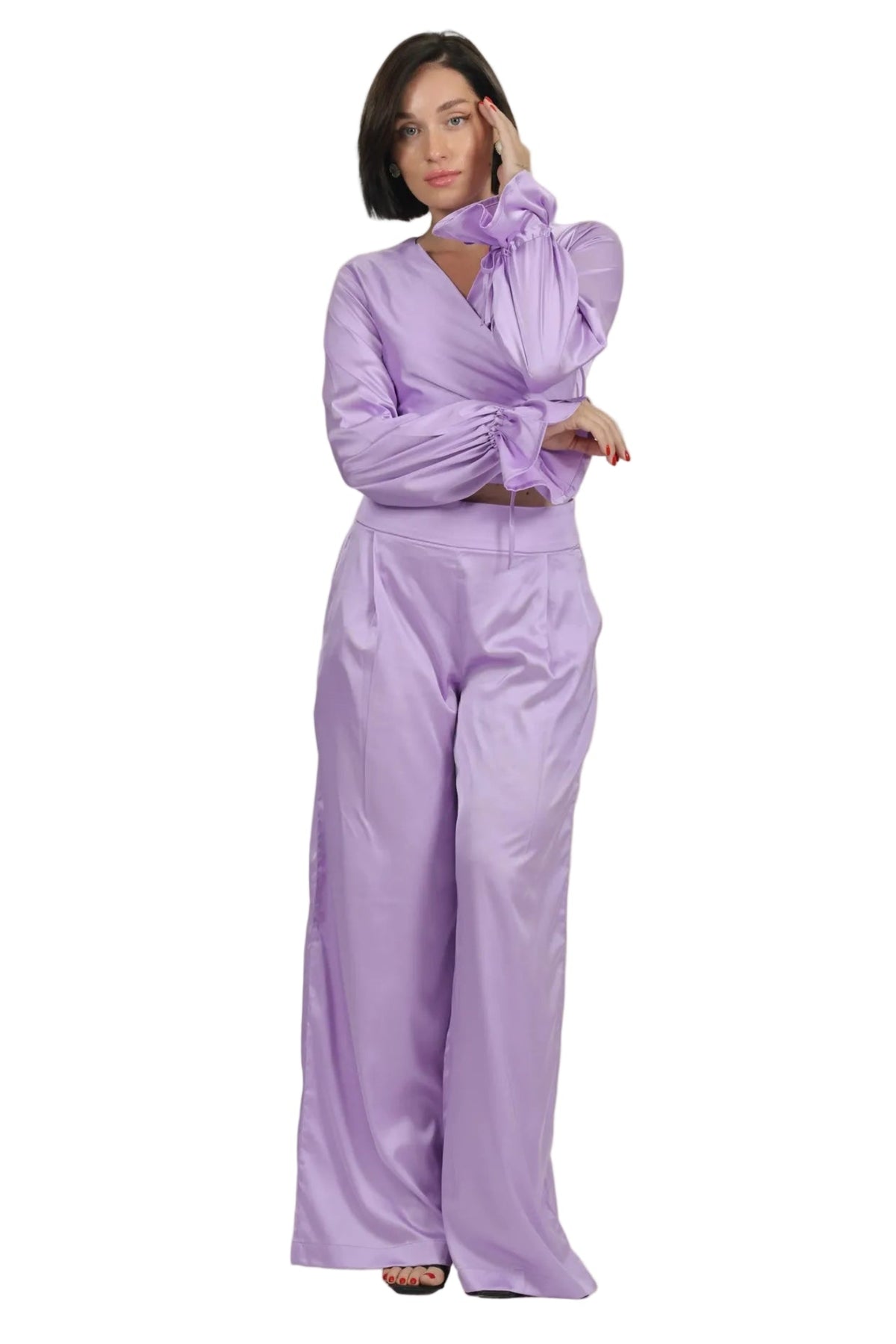 Woman wearing a lavender outfit on a beige background