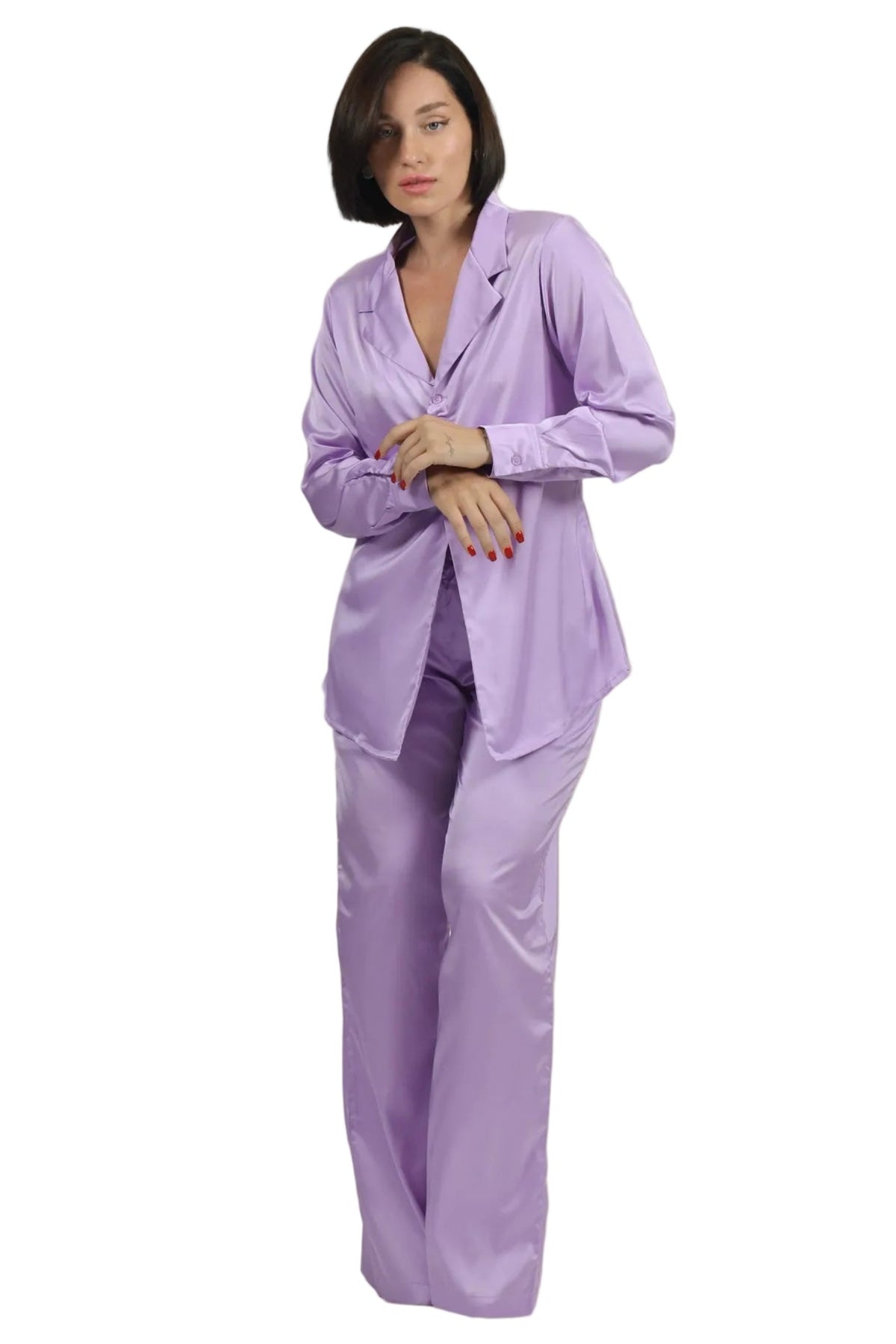 A woman modeling a lavender satin pajama set consisting of a long-sleeve button-up top and matching wide-leg pants, set against a plain white background.