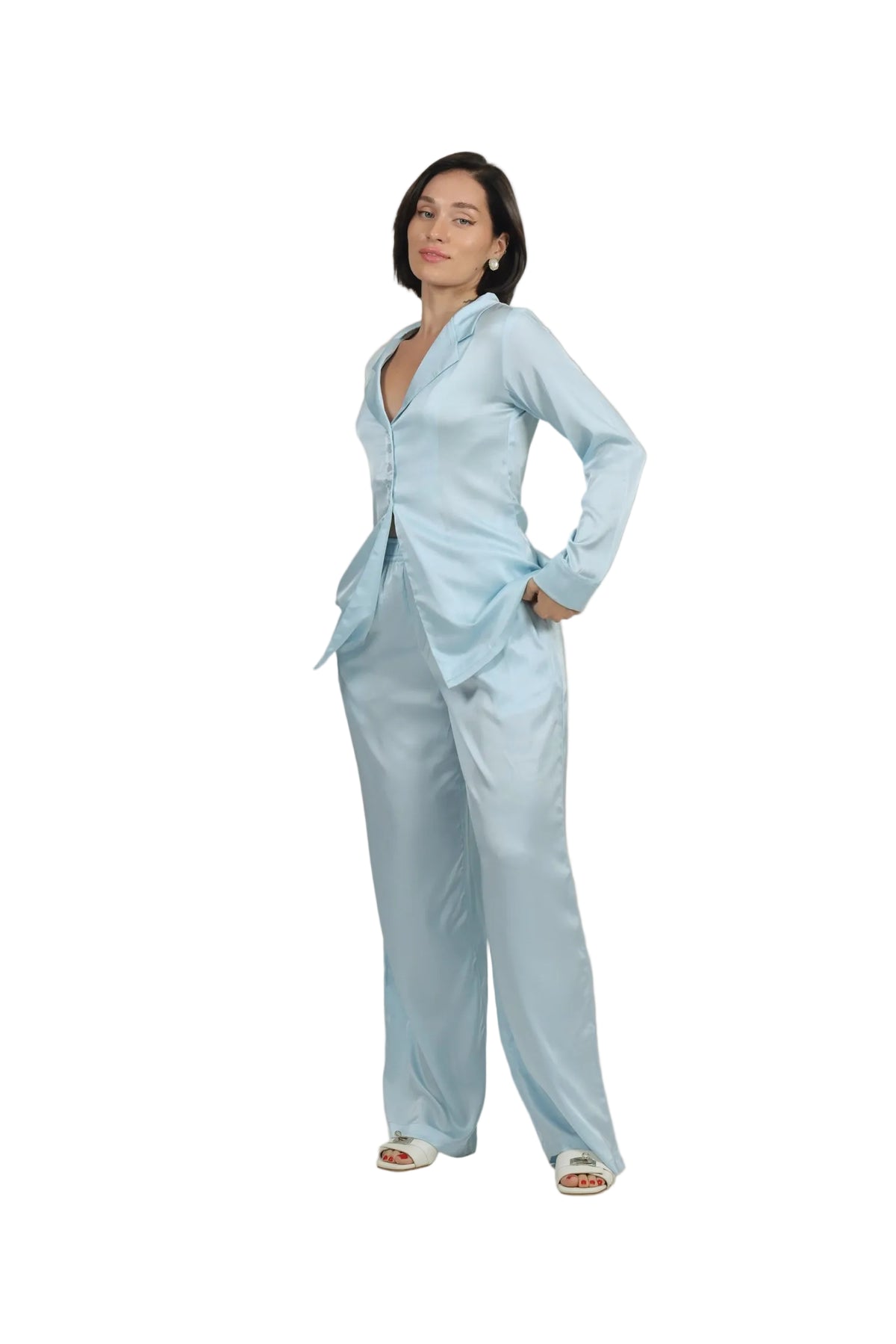 Woman wearing a light blue outfit on a beige background