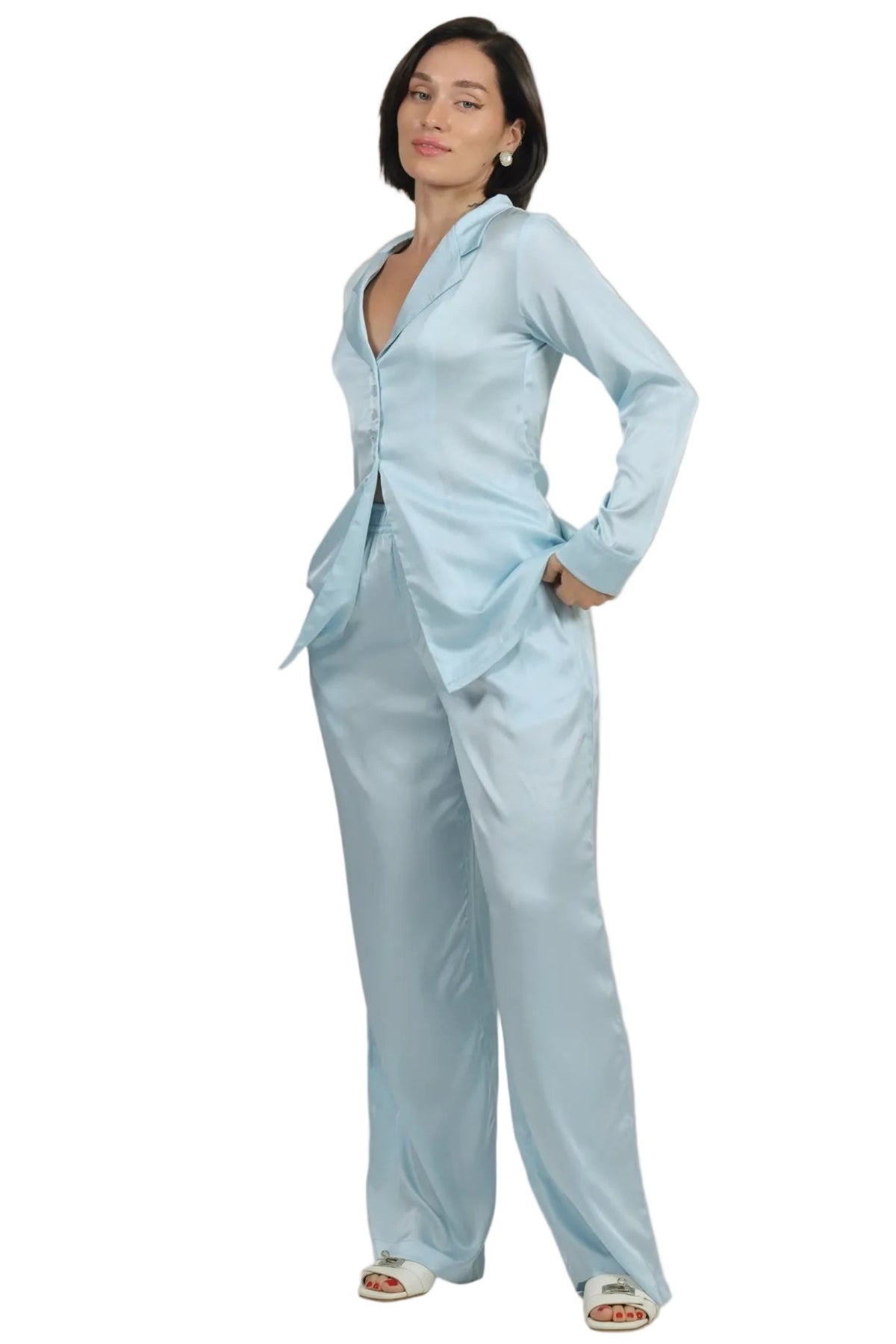 Woman wearing a light blue outfit on a beige background