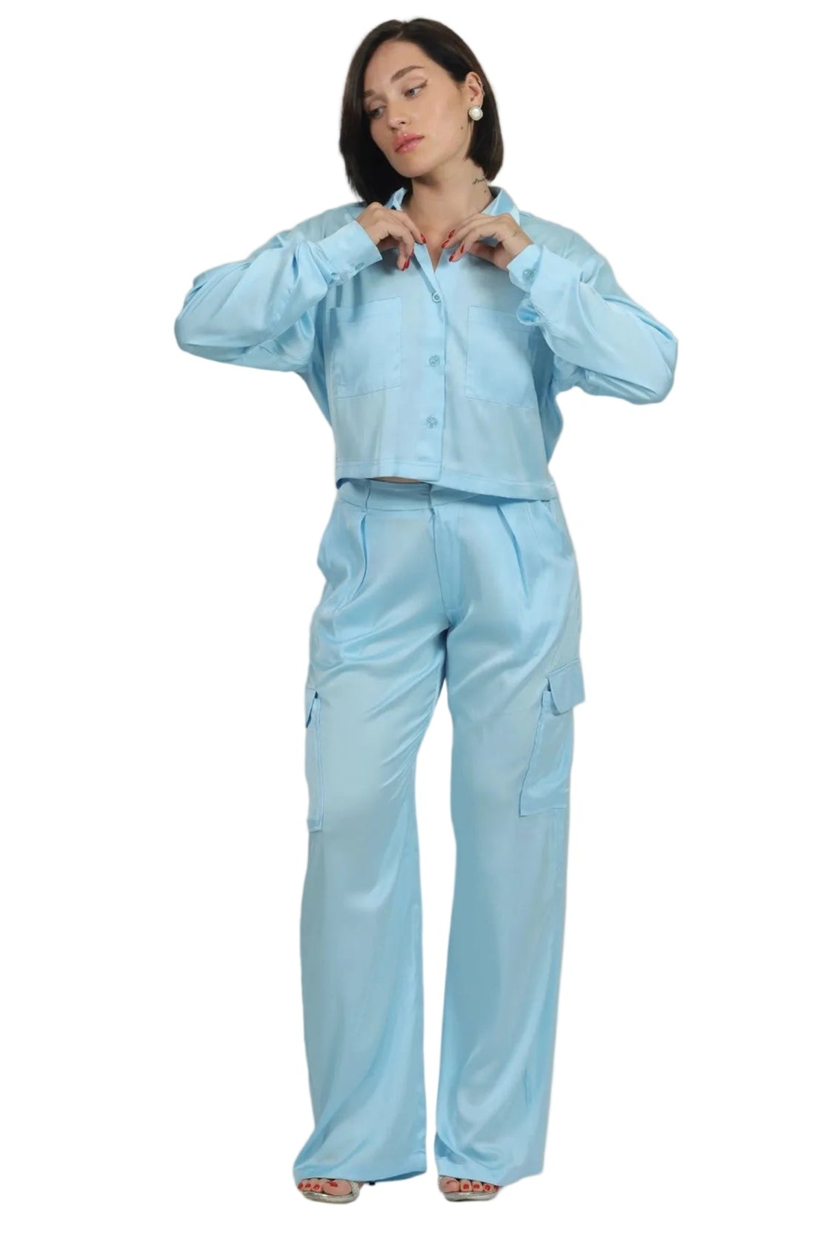 Person wearing a light blue outfit on a beige background