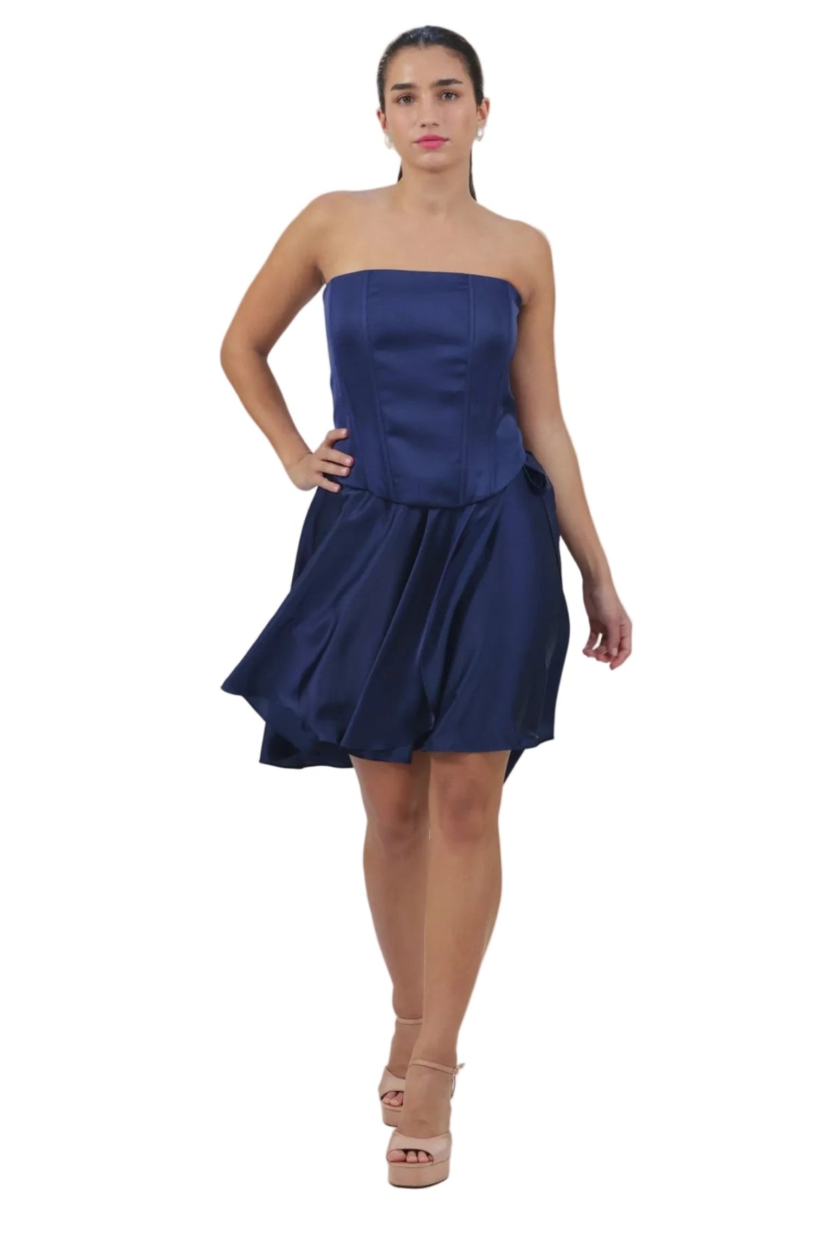 Woman wearing a strapless navy blue dress on a beige background