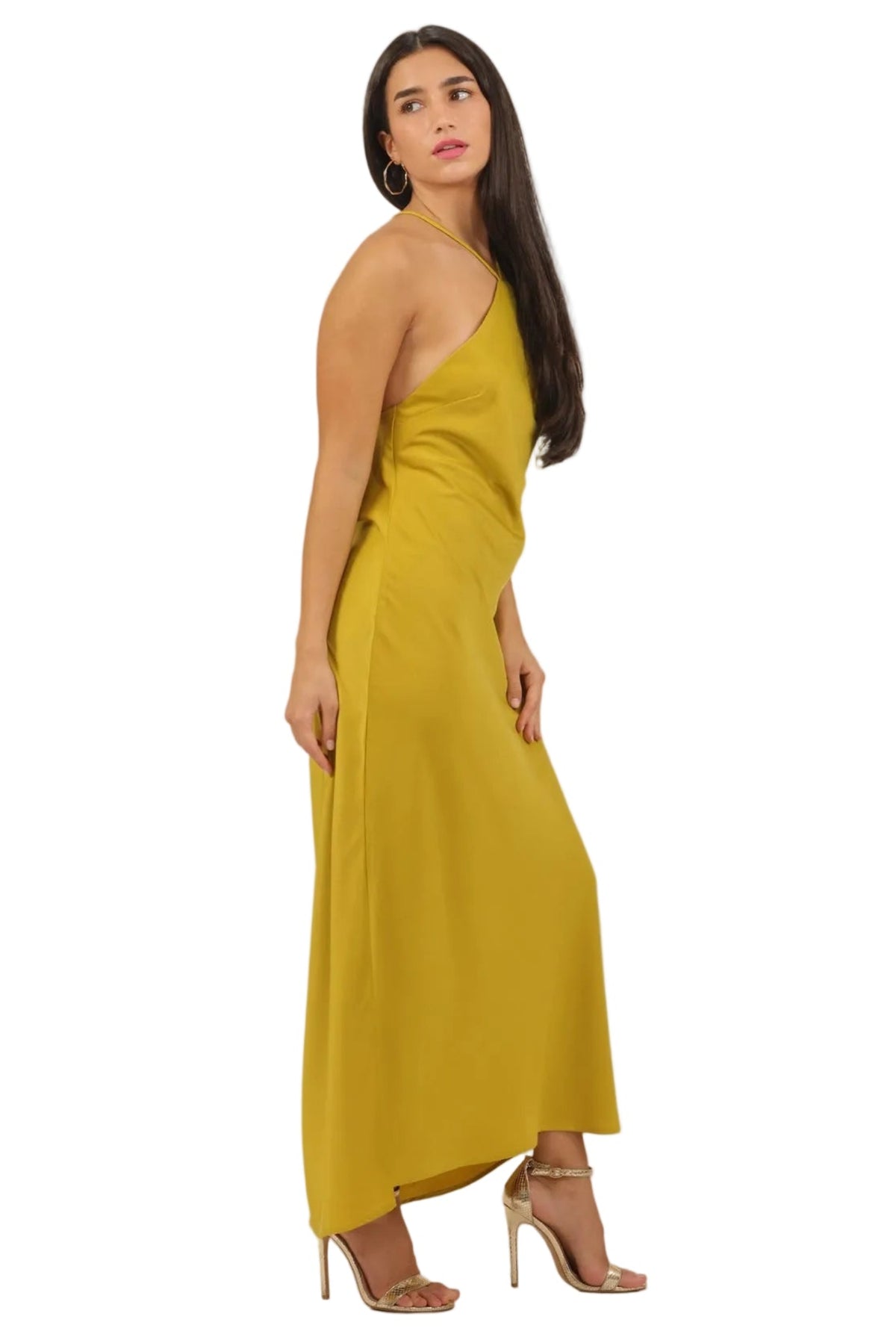 A woman modeling a one-shoulder mustard yellow maxi dress, shown from a side-back angle against a solid white background.