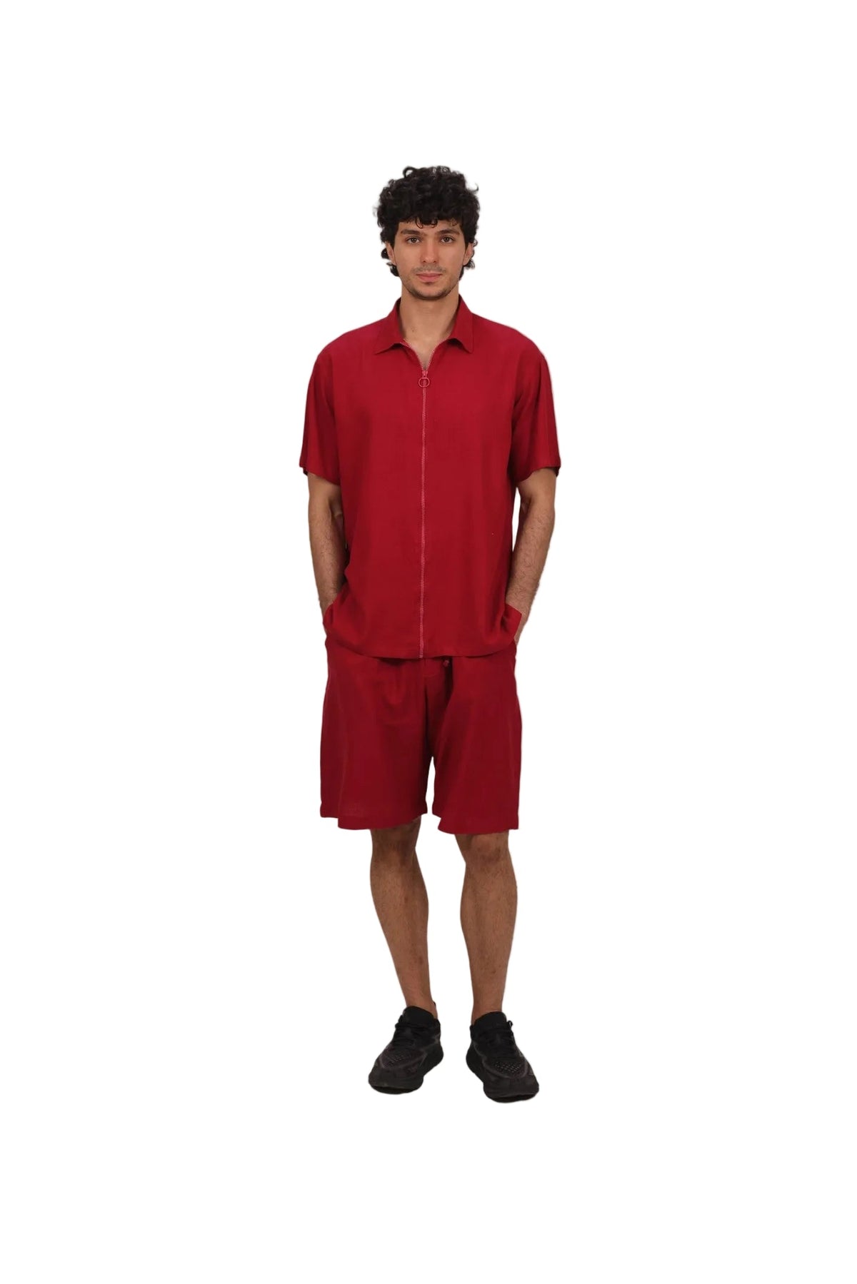 Person wearing a red outfit on a beige background