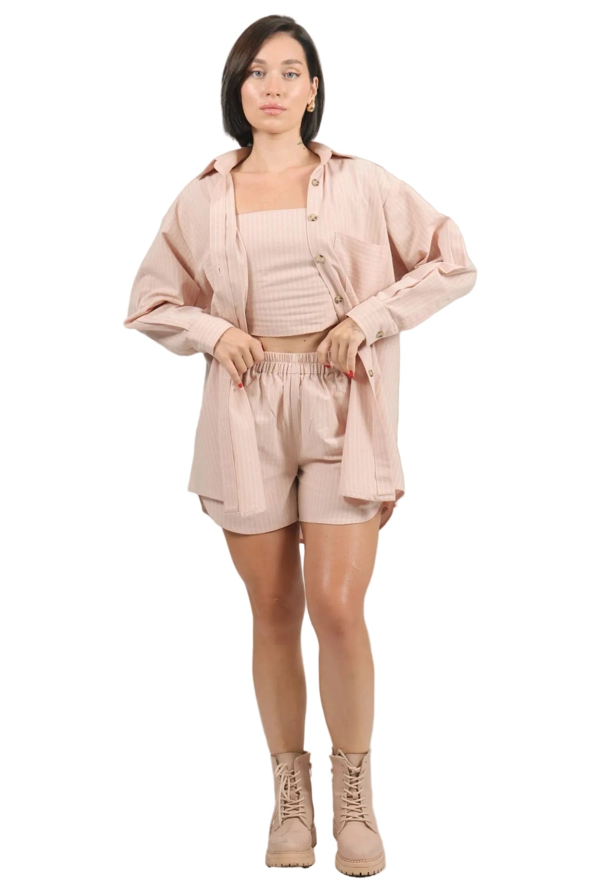 Woman wearing a pink outfit with a beige background