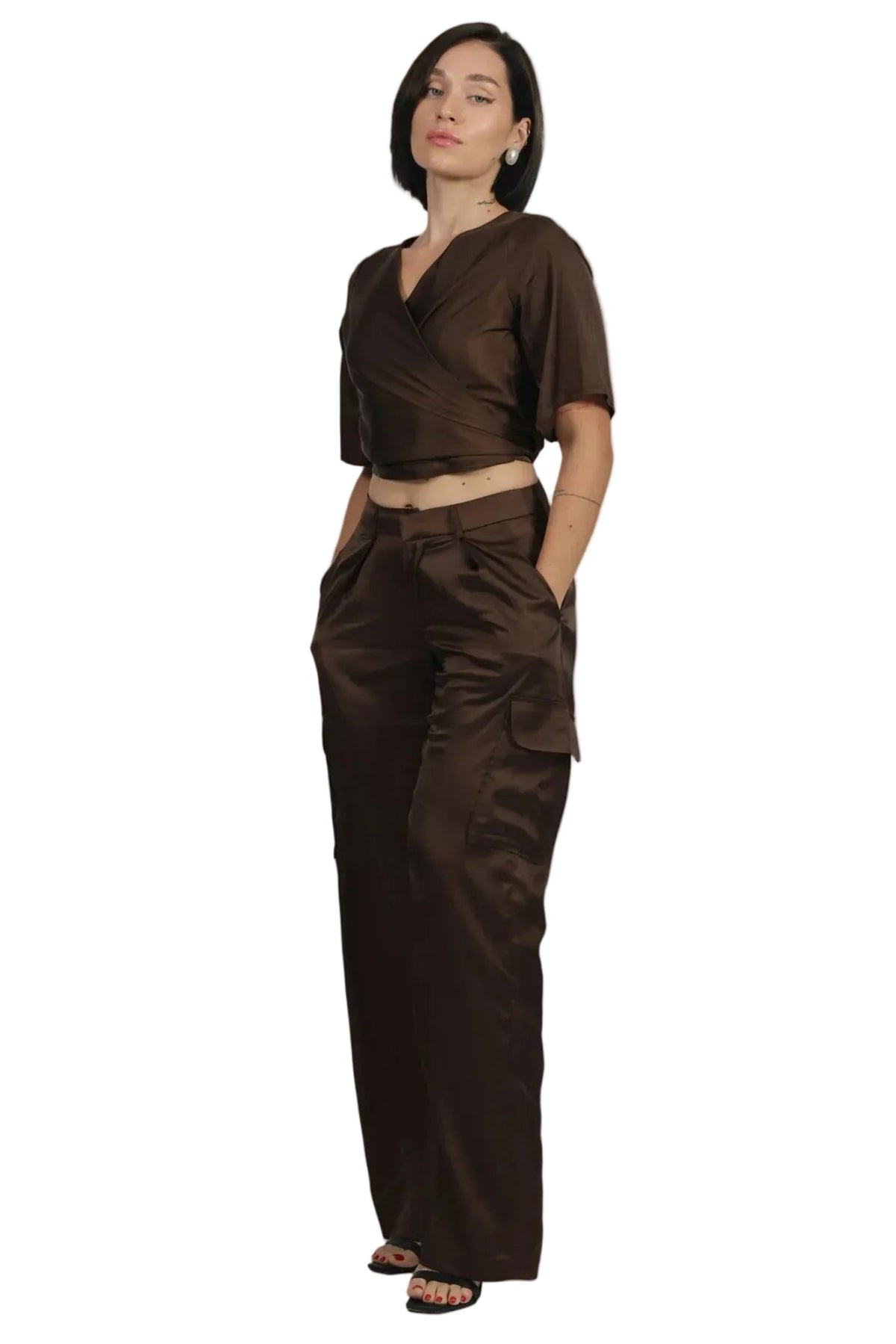 Woman wearing a brown outfit on a beige background