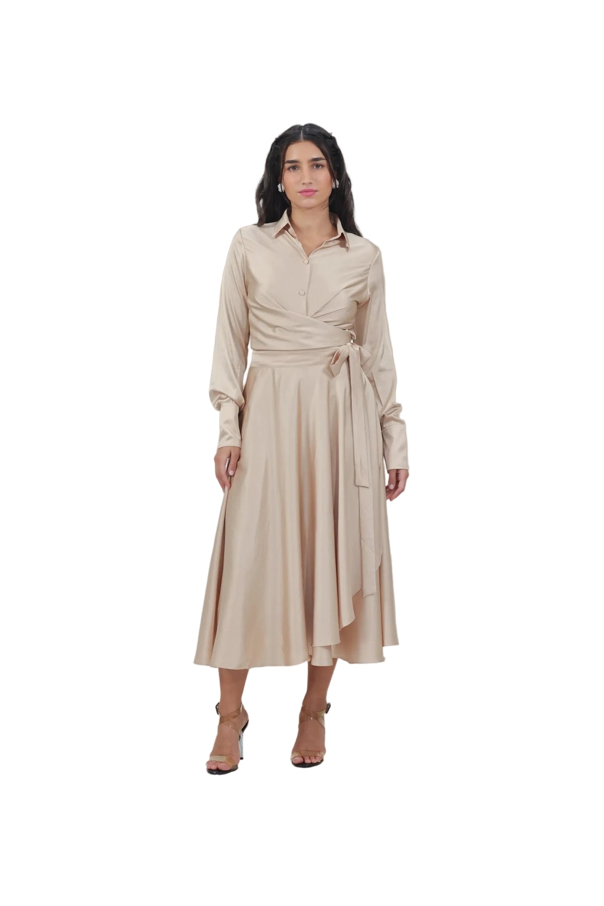 Woman wearing a beige dress against a plain background