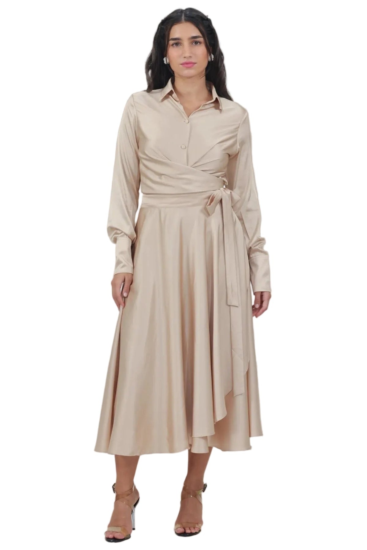 Woman wearing a beige dress against a plain background
