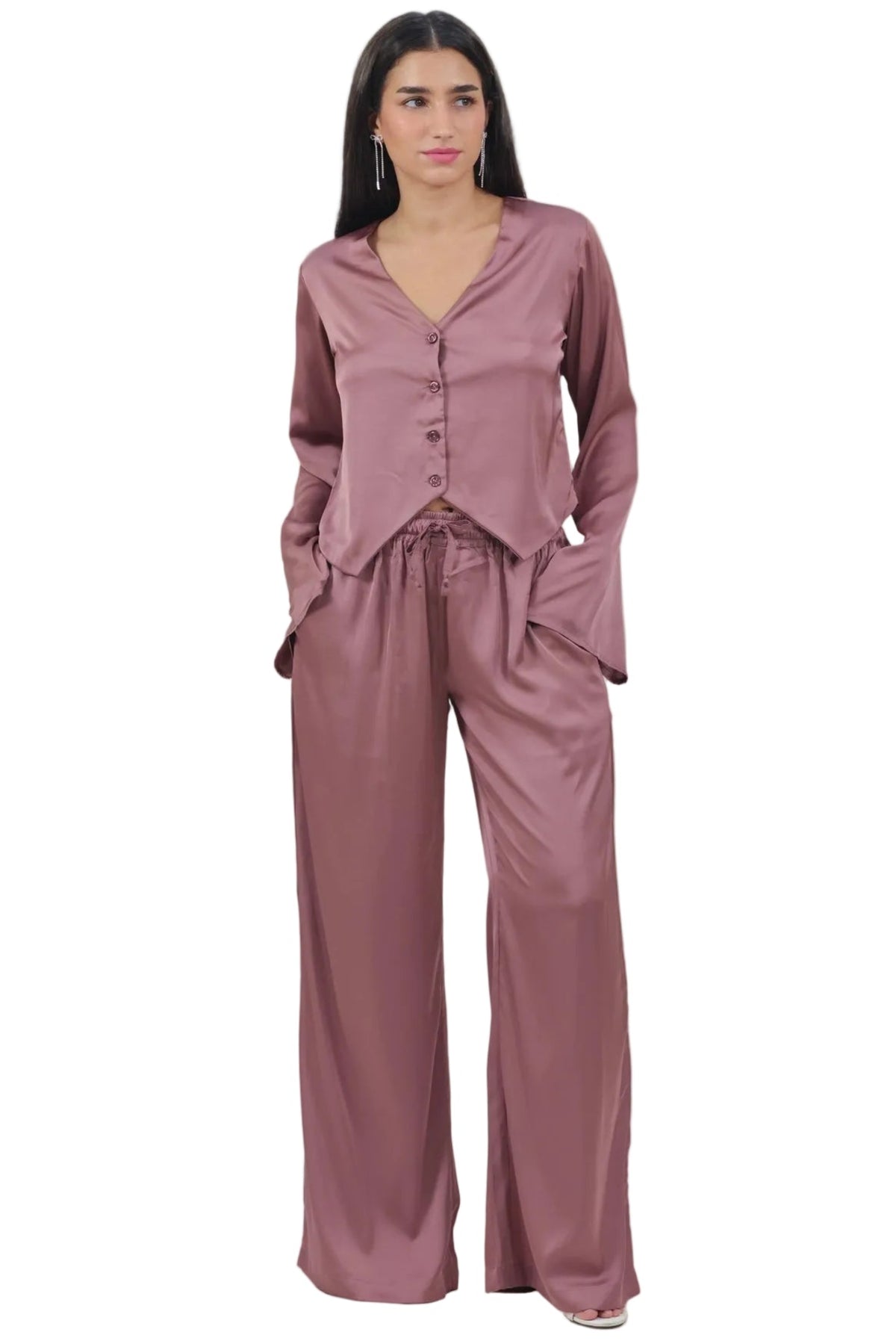 A woman modeling a matching dusty rose two-piece lounge set consisting of a long-sleeve button-front top and wide-leg pants, shot against a plain white background.