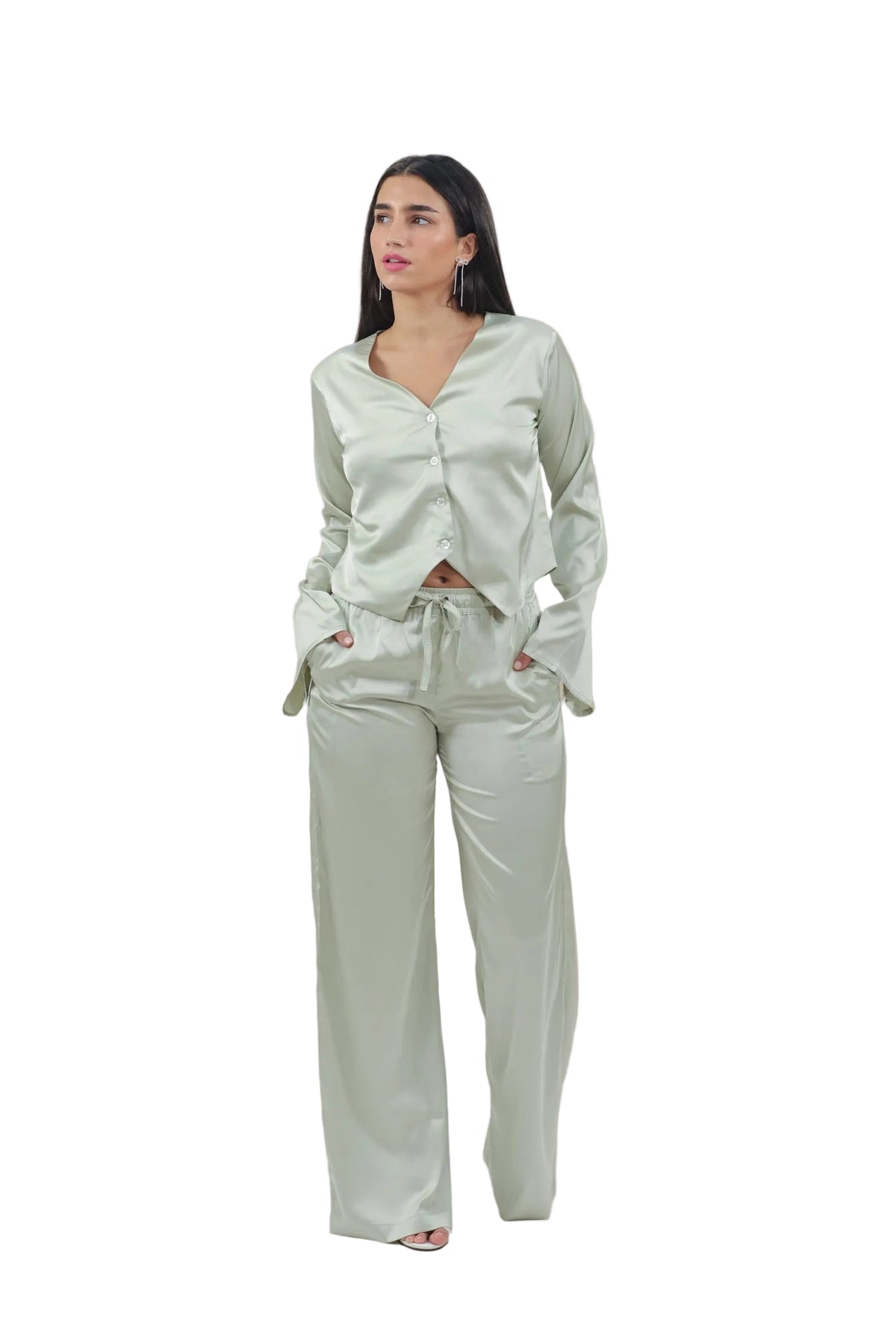 Woman wearing a light green outfit on a beige background