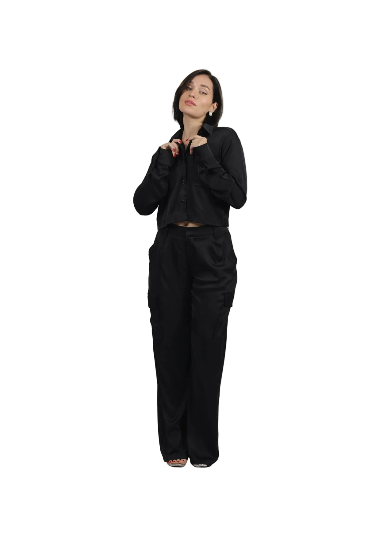 Woman wearing a black outfit on a beige background