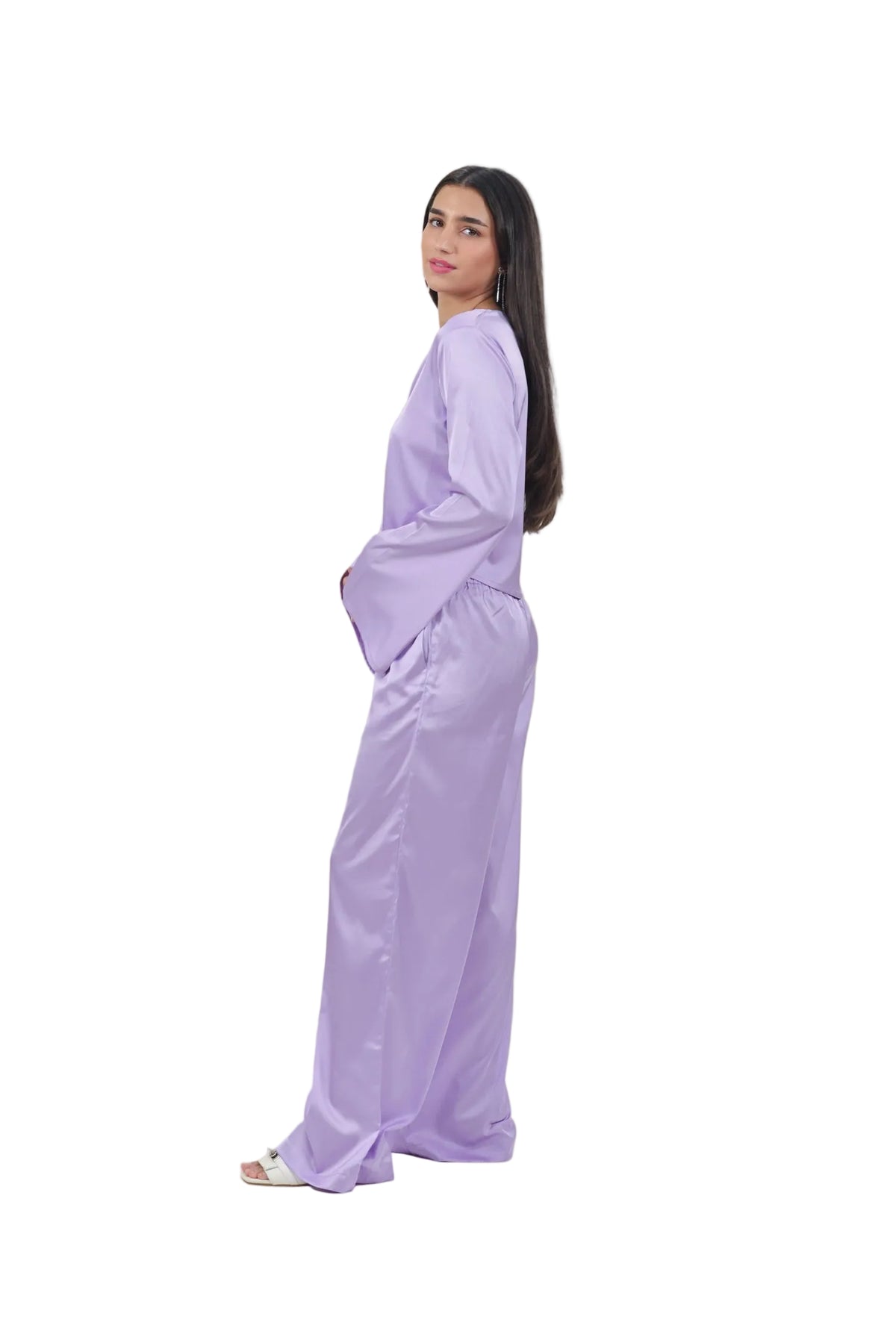 Woman wearing a light purple outfit on a beige background