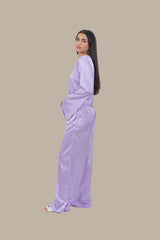 Woman wearing a light purple outfit on a beige background