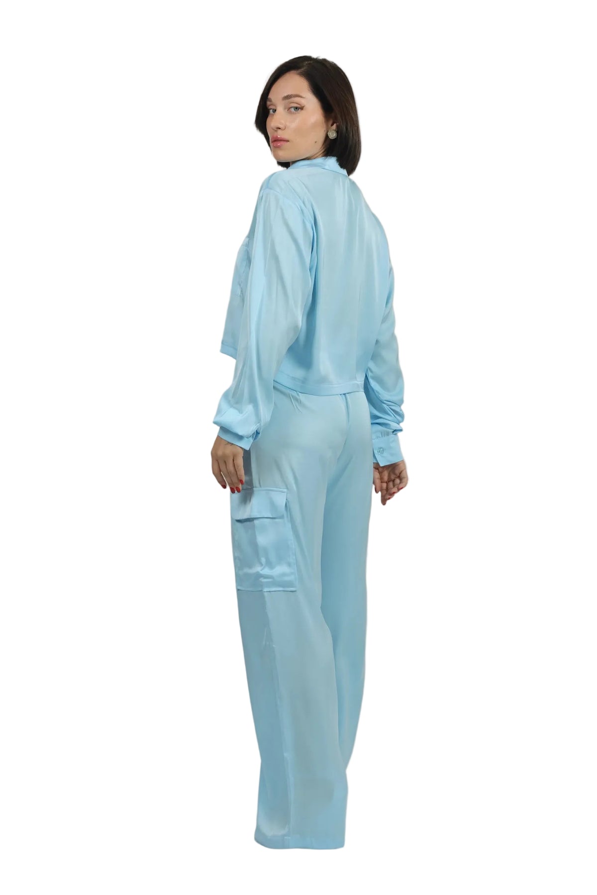 Woman wearing a light blue outfit on a beige background