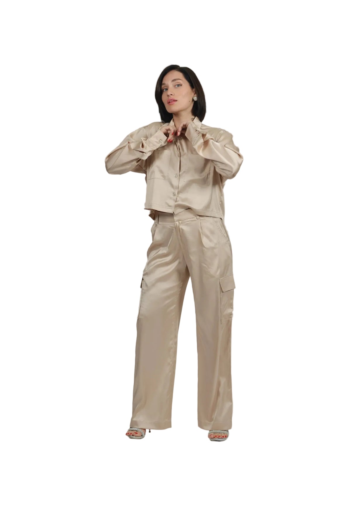 Woman wearing a beige outfit on a plain background