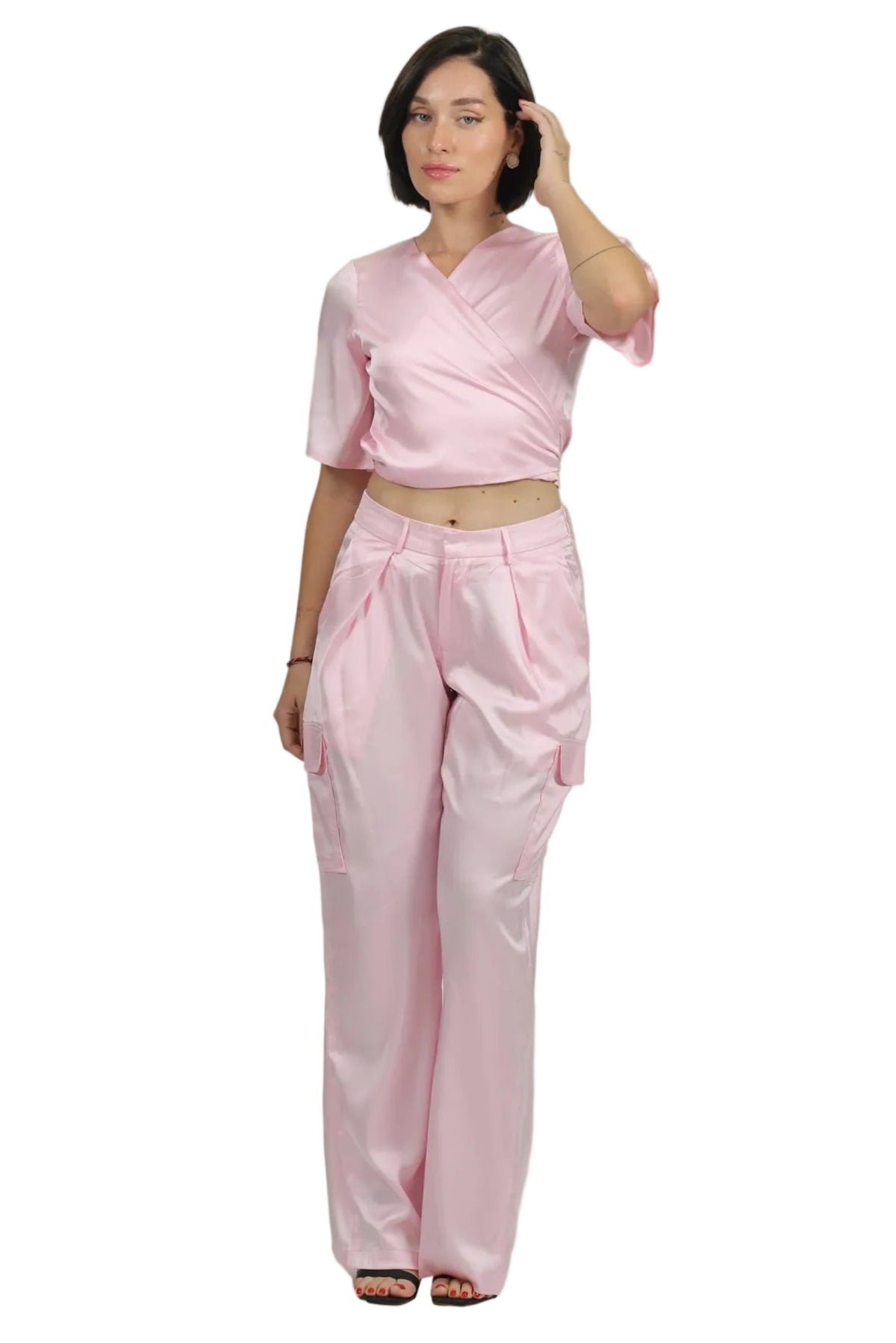 Woman wearing a pink outfit on a beige background