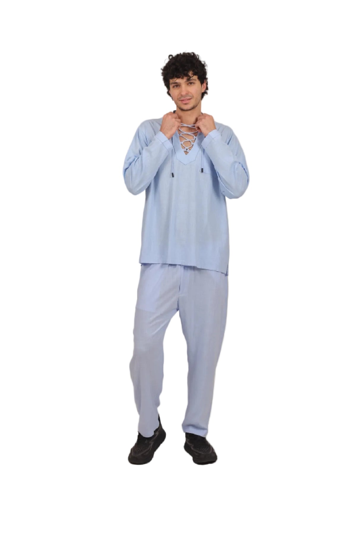 Person wearing a light blue outfit on a beige background