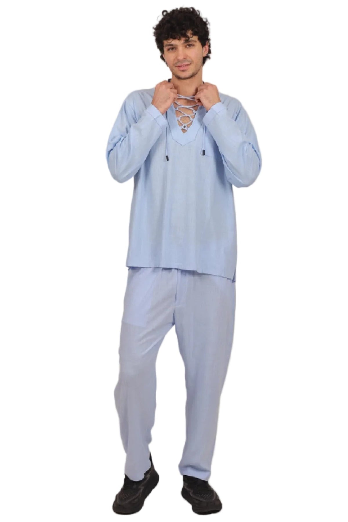 Person wearing a light blue outfit on a beige background