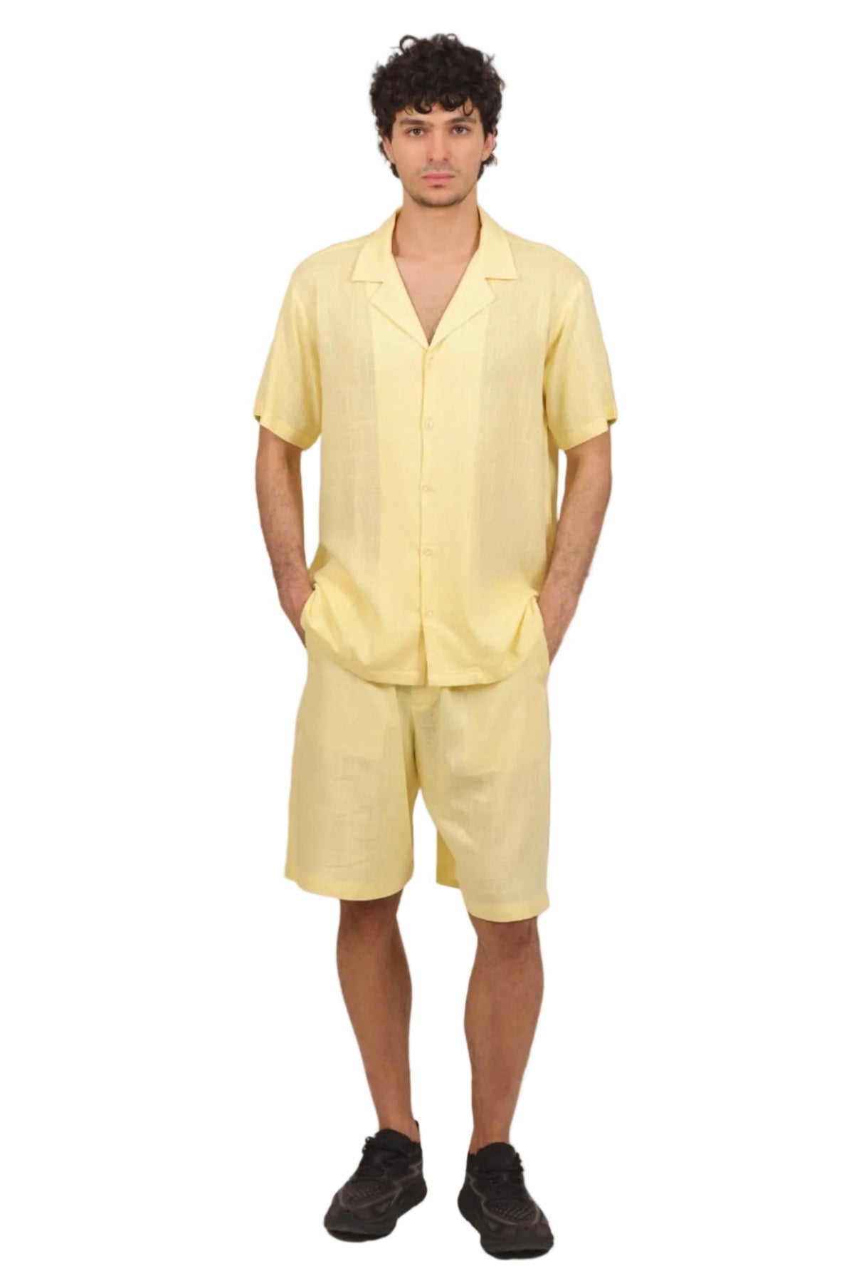 Man wearing a yellow outfit on a beige background