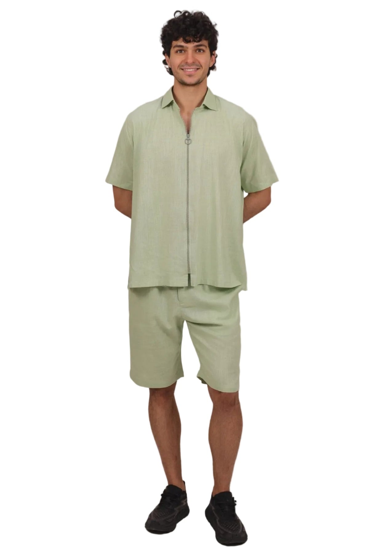 Man wearing a light green outfit on a beige background