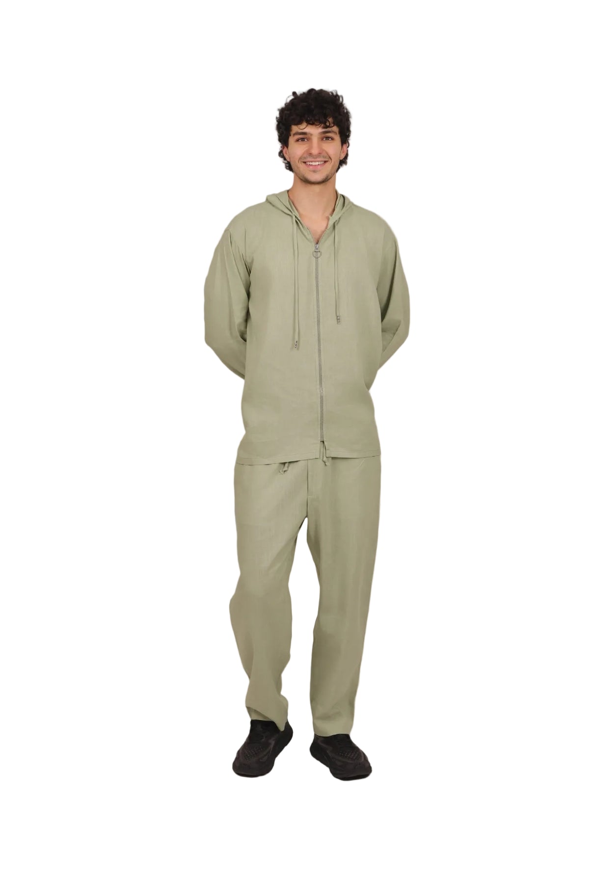 Person wearing a green tracksuit on a beige background