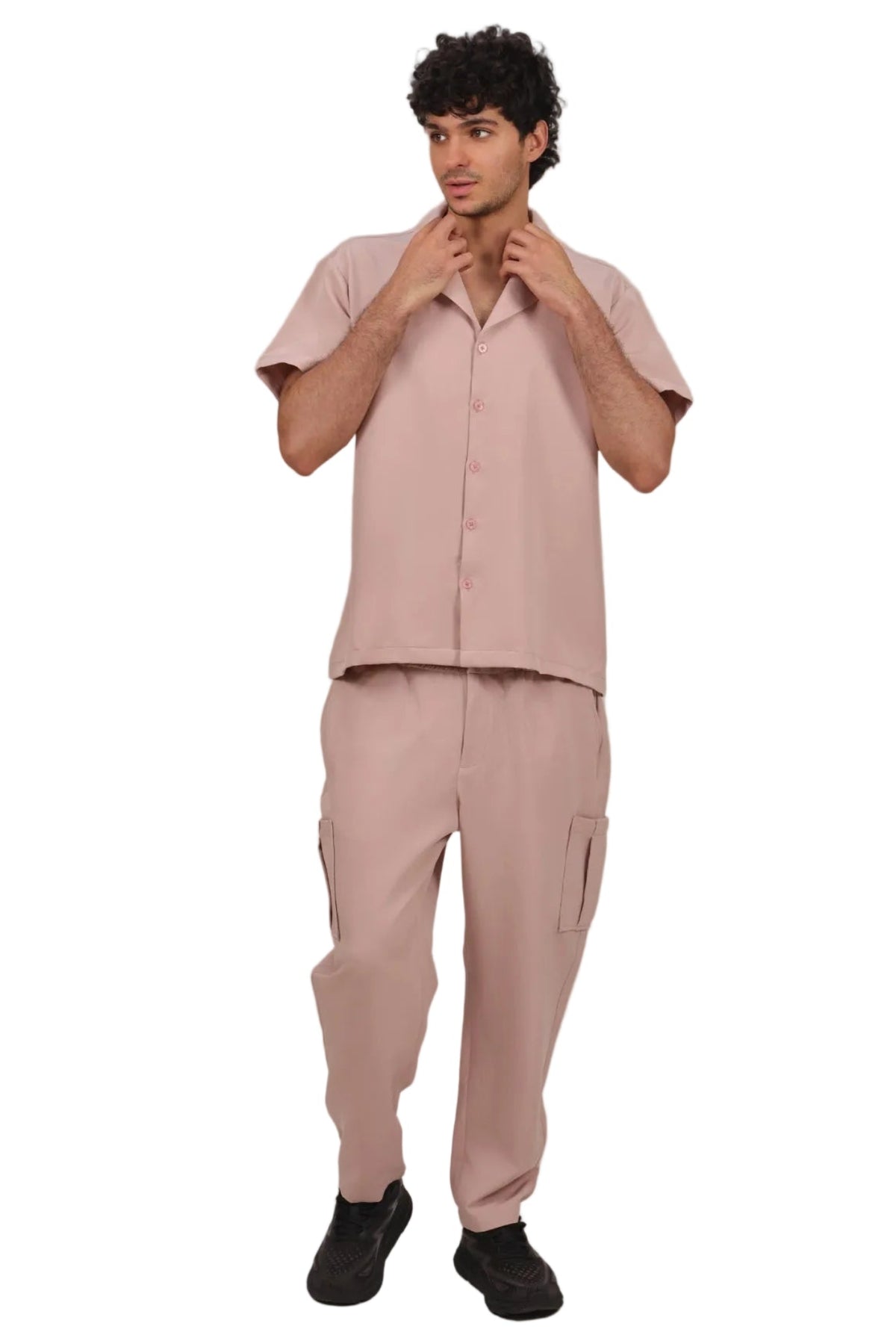 Man wearing a pink outfit on a beige background