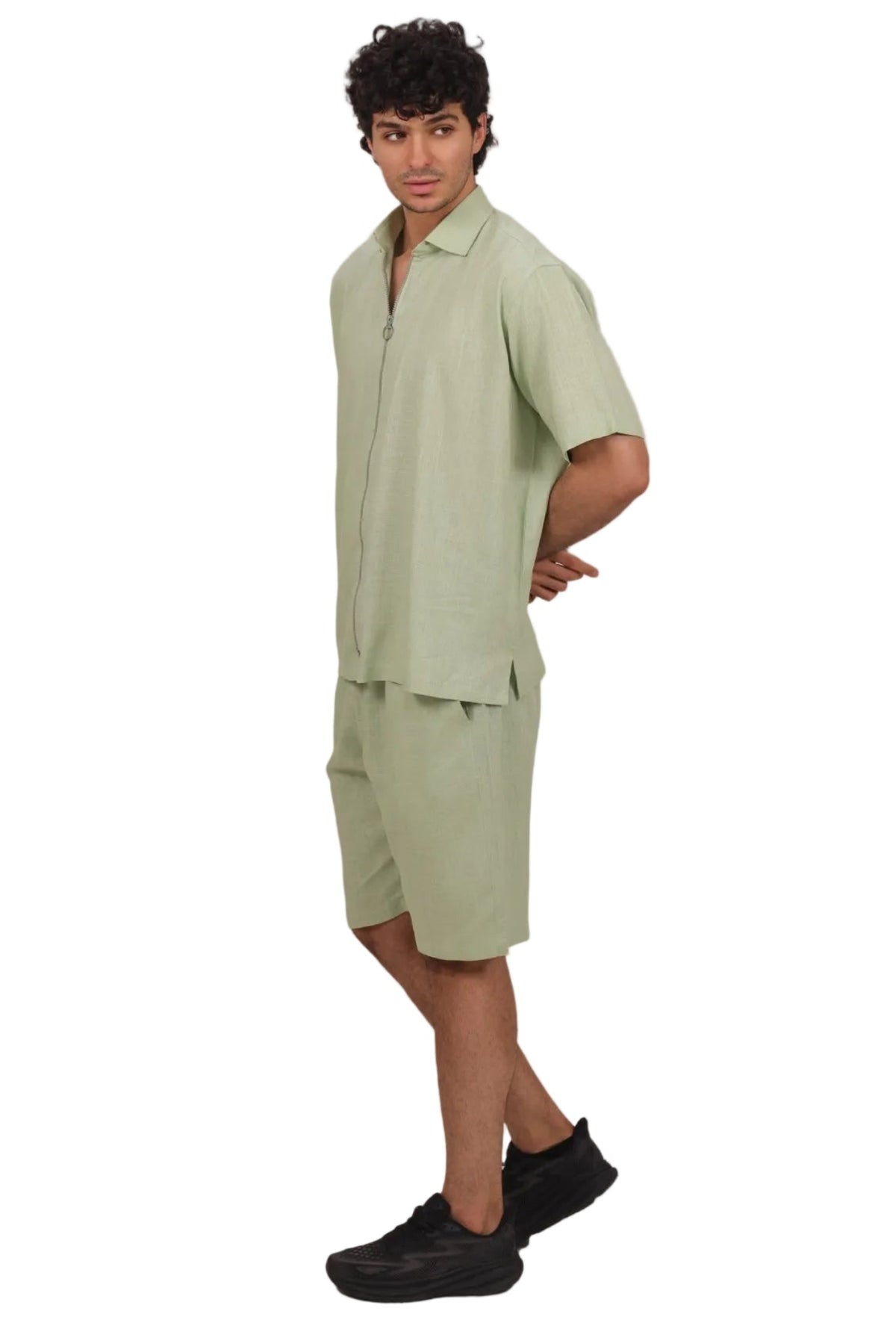 Person wearing a light green outfit on a beige background
