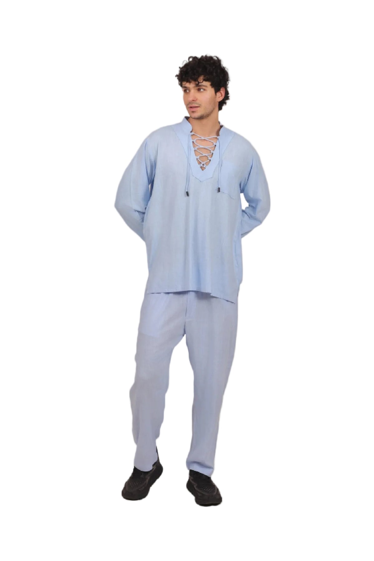 Man wearing a light blue outfit on a beige background