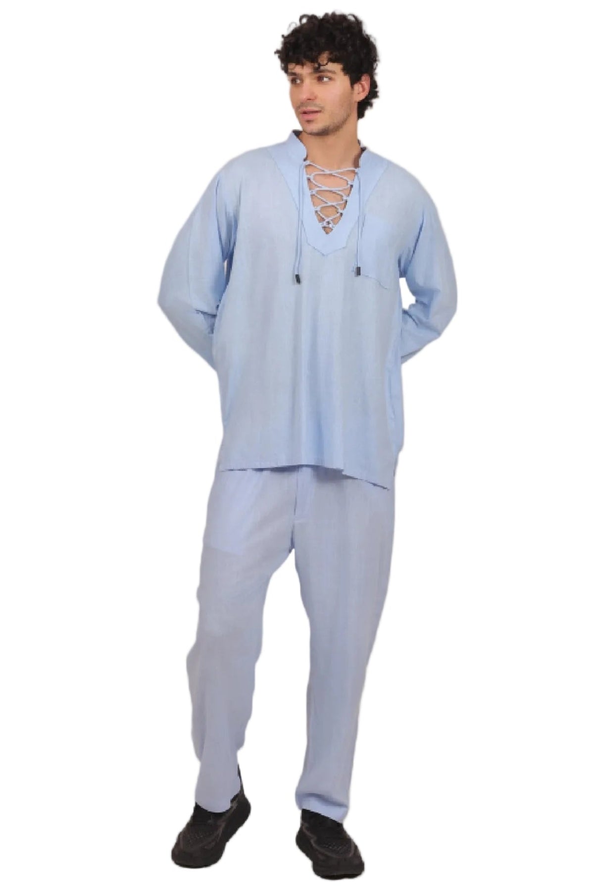 Man wearing a light blue outfit on a beige background