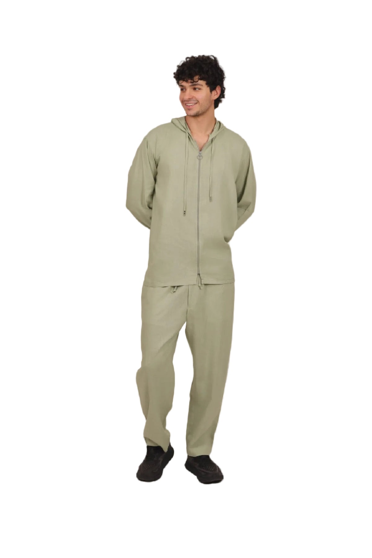 Man wearing a green tracksuit on a beige background