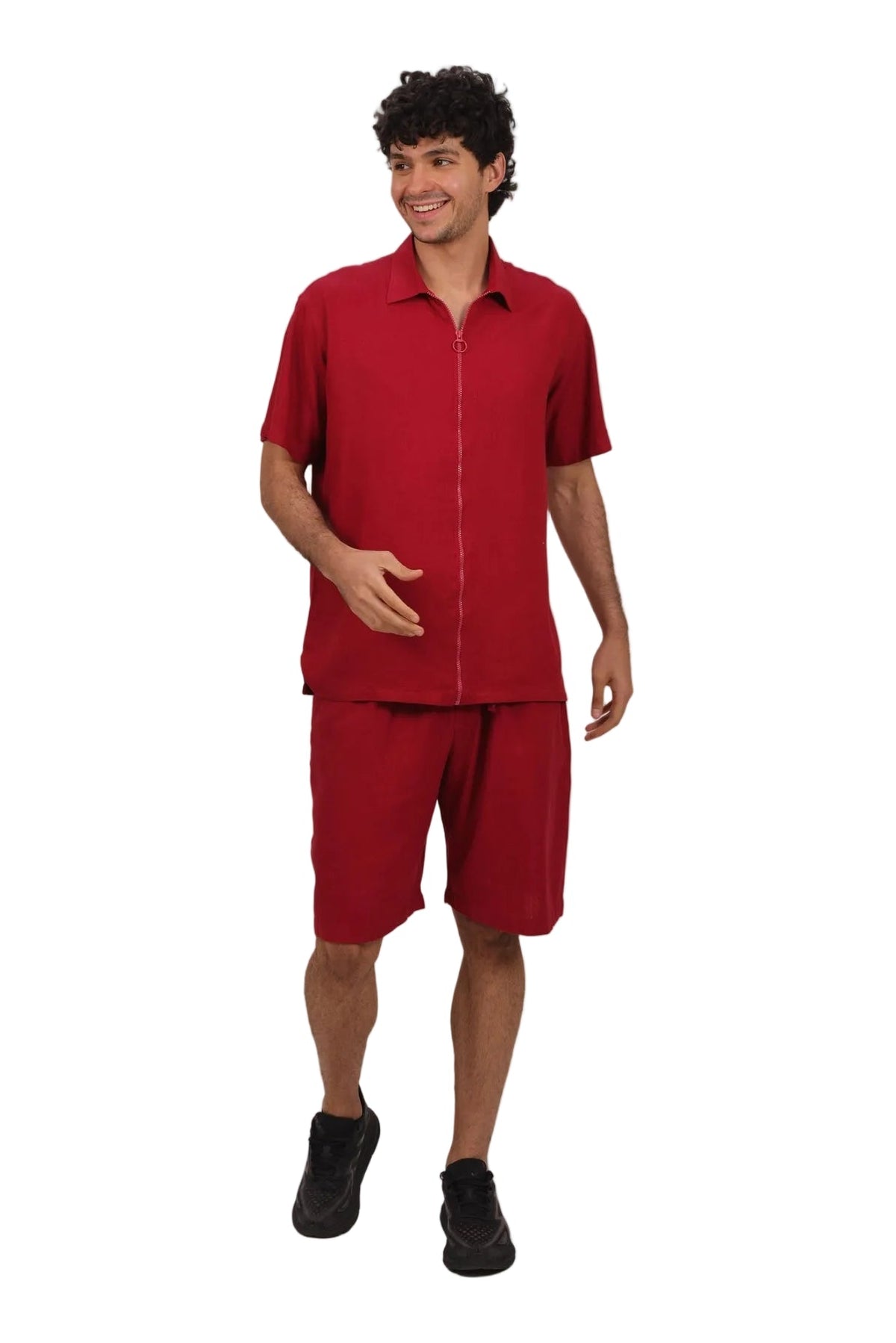 A man modeling a matching red short-sleeve button-up shirt and shorts set, standing against a plain white background.
