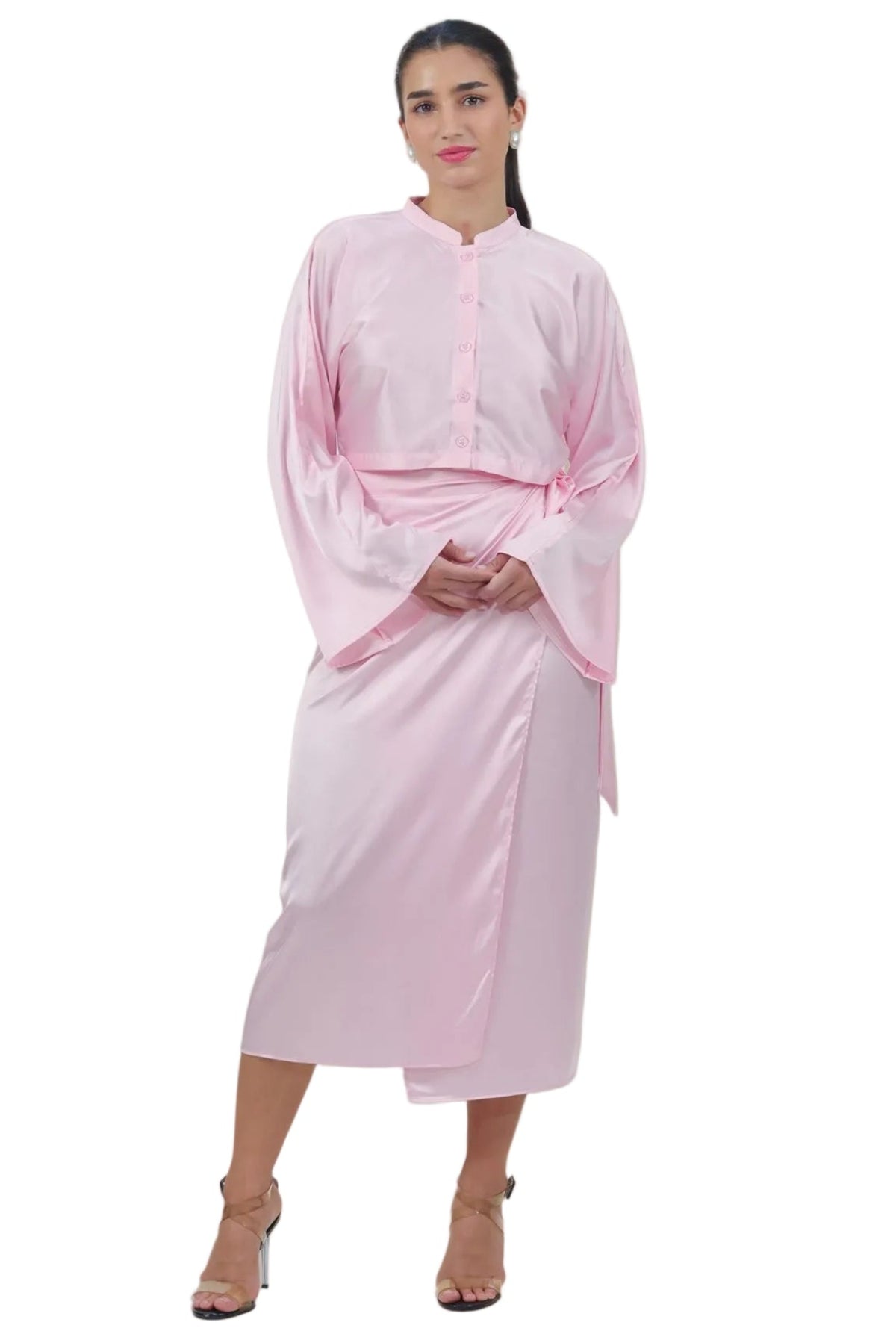 Woman wearing a light pink dress against a beige background