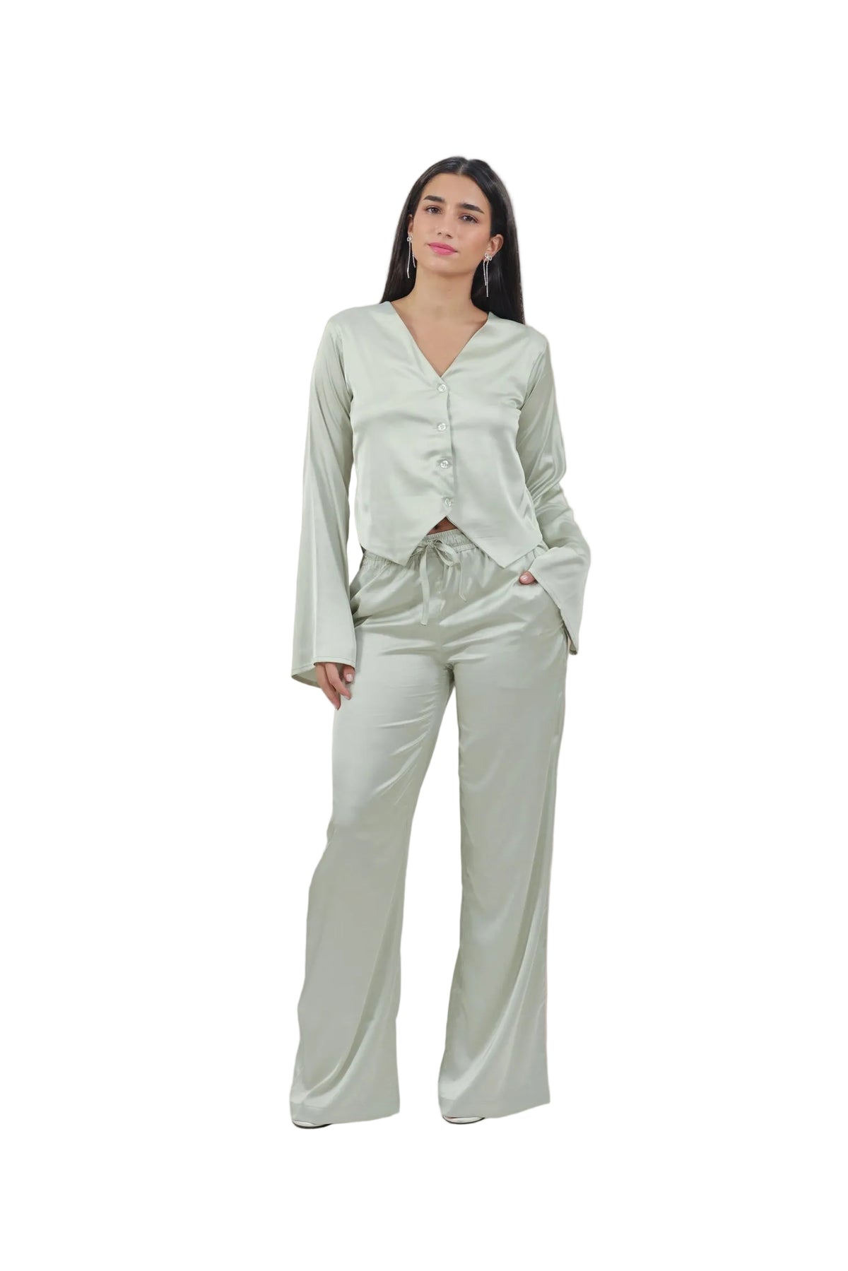 Woman wearing a light green outfit on a beige background