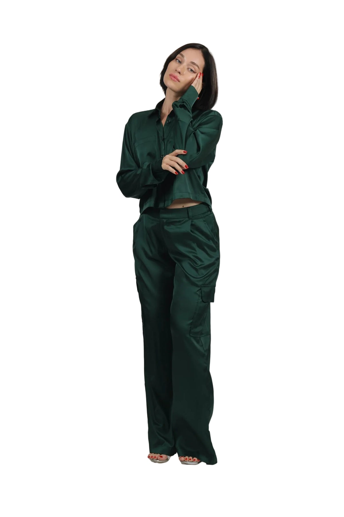 Woman wearing a green outfit against a beige background