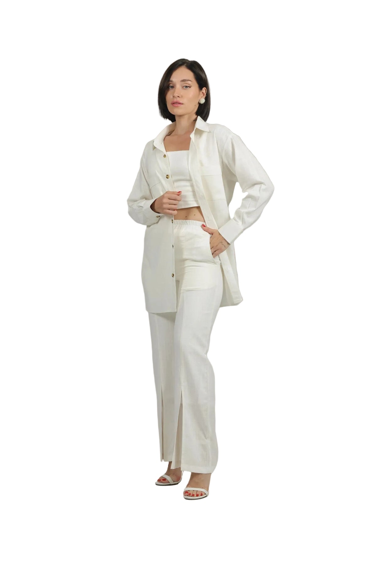 Woman wearing a white suit standing against a beige background