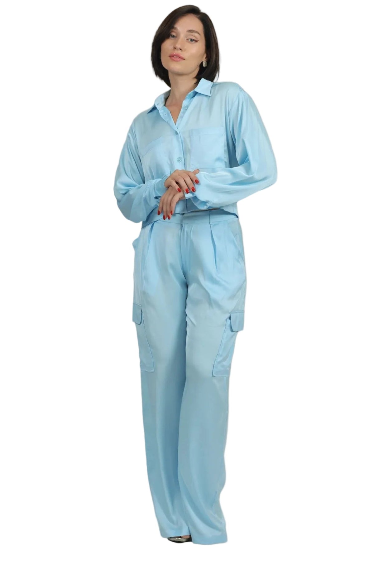 Woman wearing a light blue outfit on a beige background