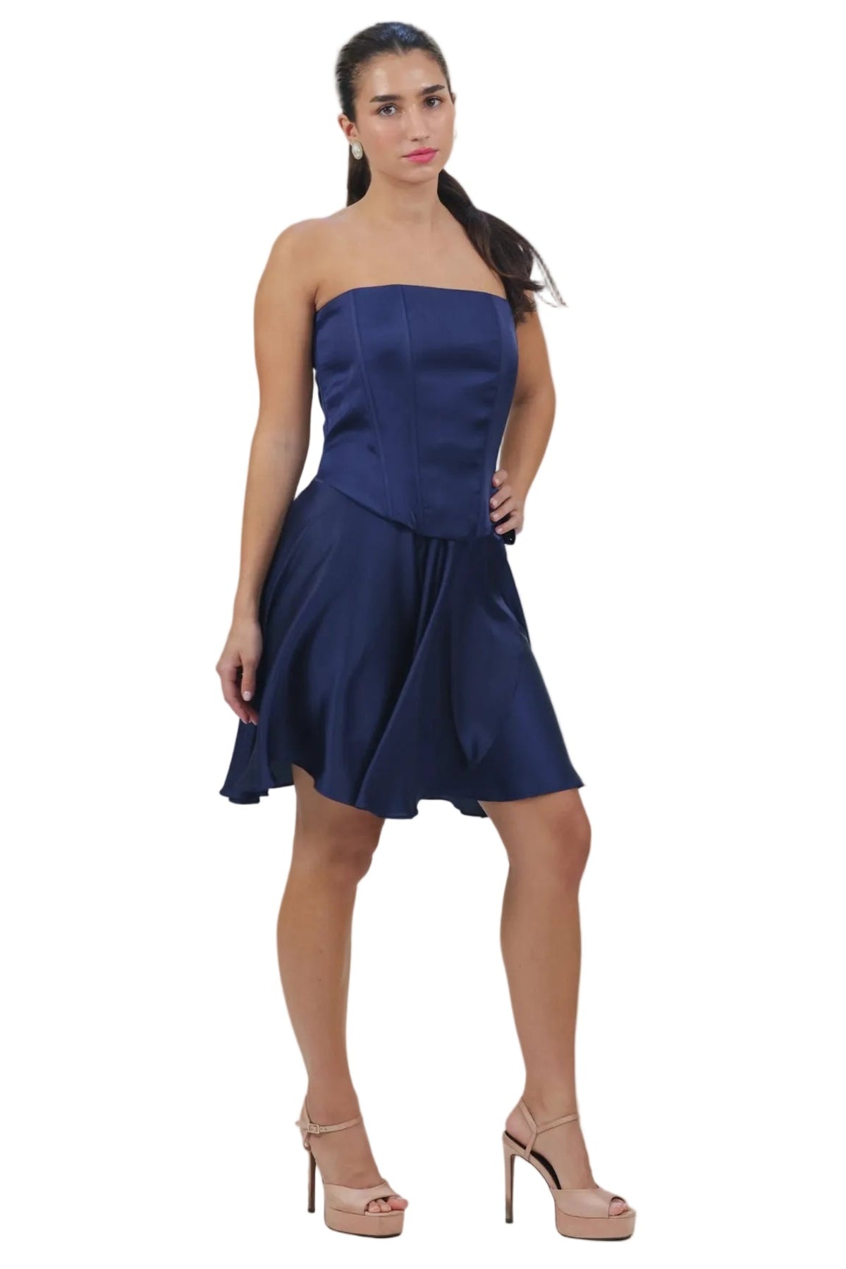 Woman wearing a strapless navy blue dress on a beige background