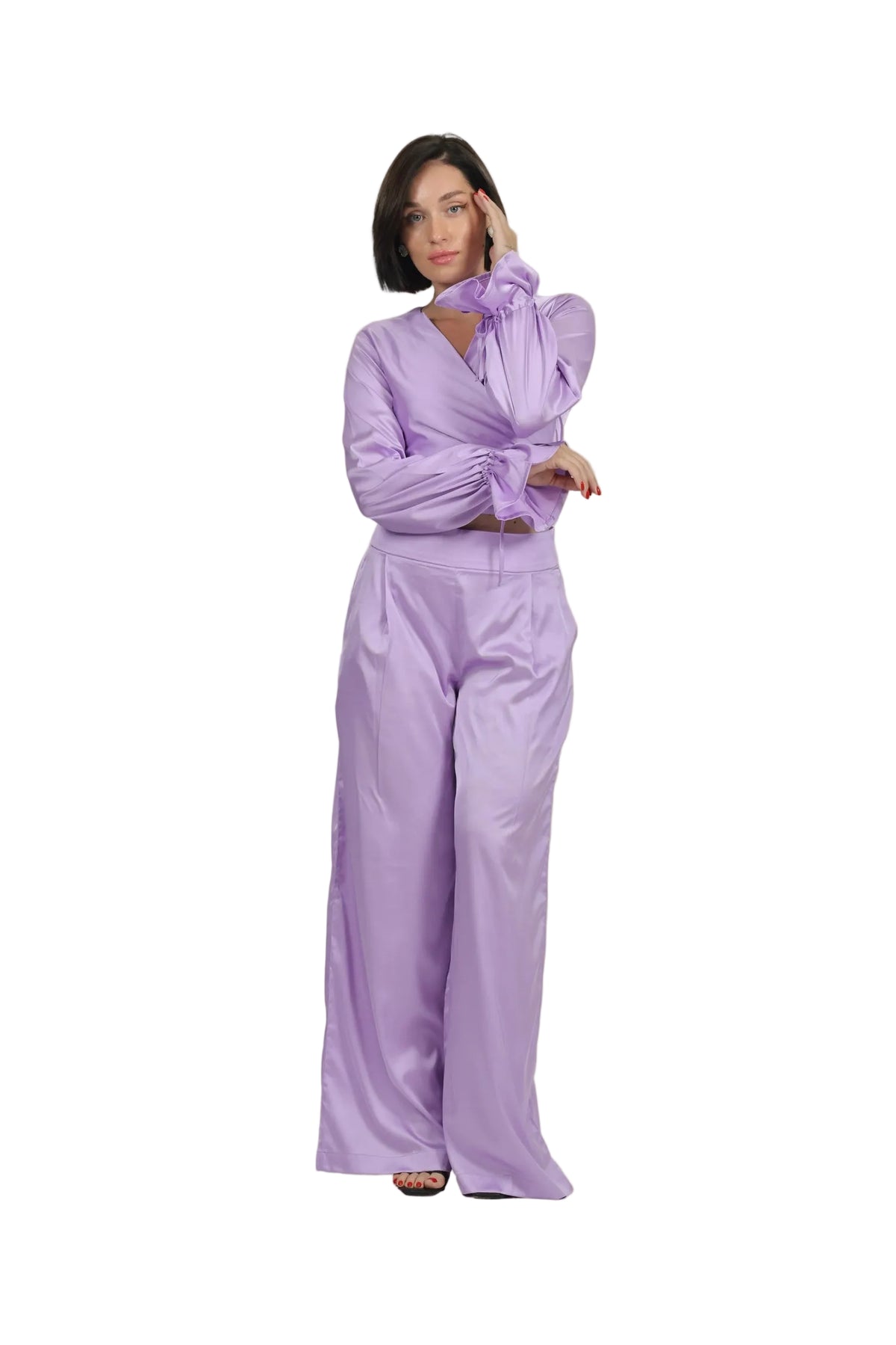 Woman wearing a lavender outfit on a beige background