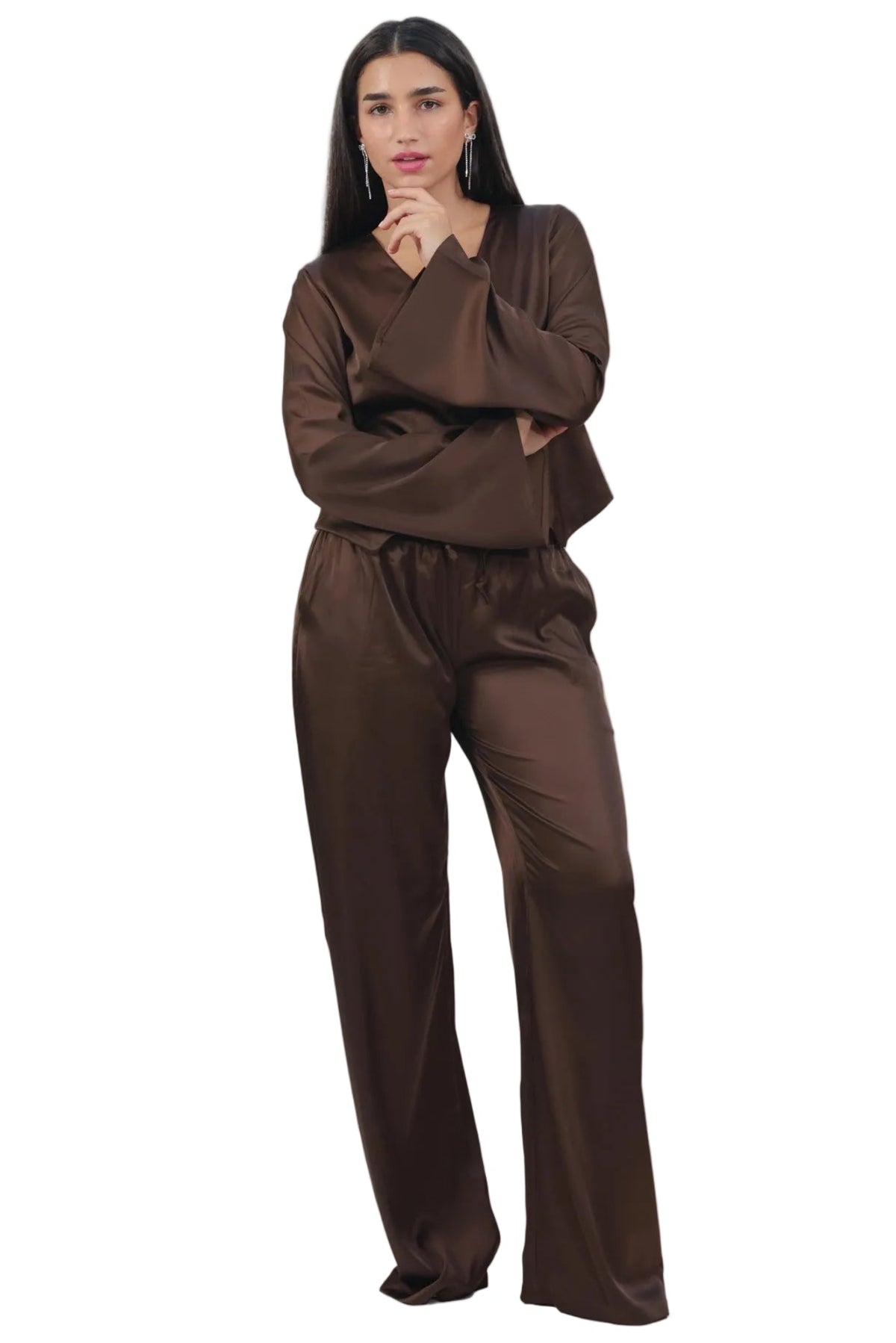 Woman wearing a brown outfit on a beige background