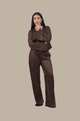 Woman wearing a brown outfit on a beige background