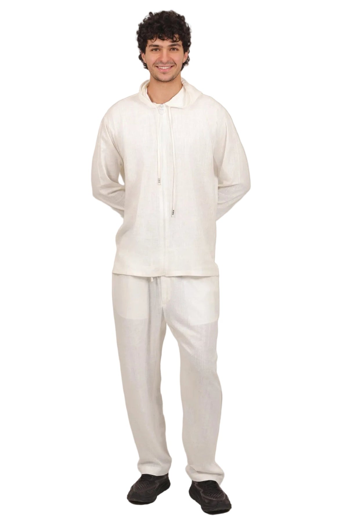 A man modeling a matching off-white lounge set consisting of a long-sleeve zip-up hoodie and sweatpants, shown against a plain white background.