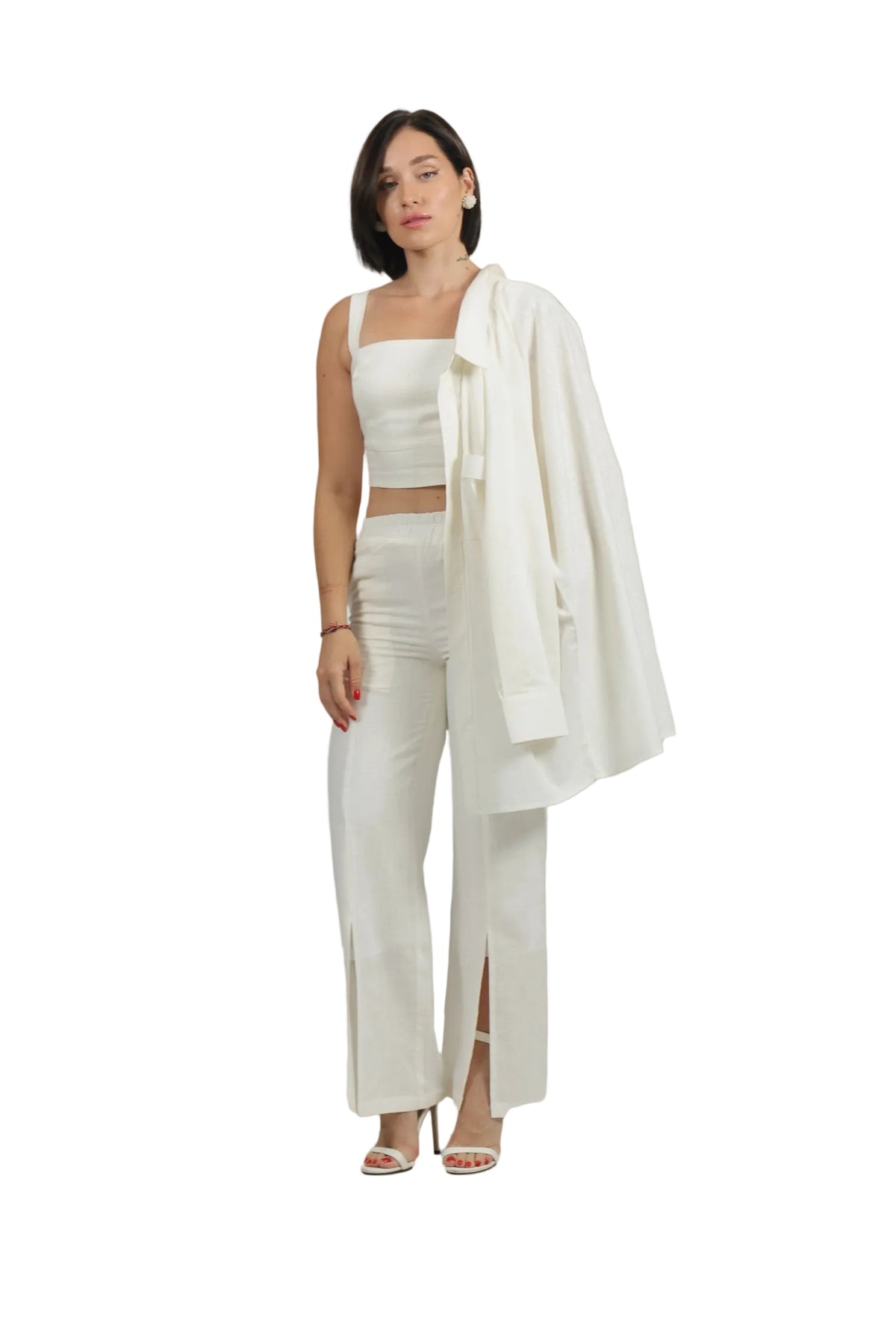 Woman wearing a white outfit with a shawl on a beige background