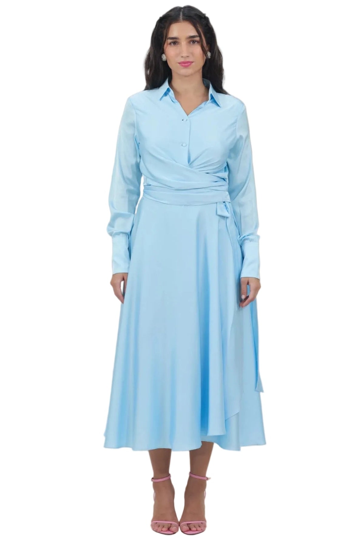 A woman modeling a light blue long-sleeve midi dress with a collared neckline, wrap-style bodice, and side tie detail, photographed against a plain white background.